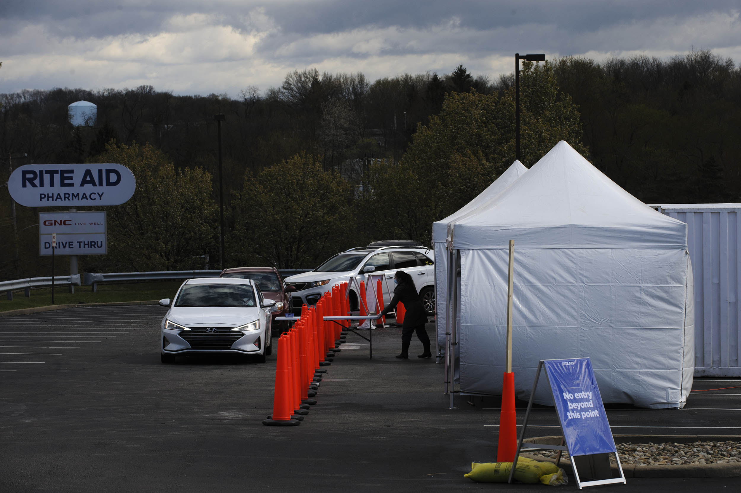 Residents in vehicles wait in line to enter a Rite Aid Corp. Covid-19 testing facility in Monroeville, Pennsylvania, on Tuesday, April 21.