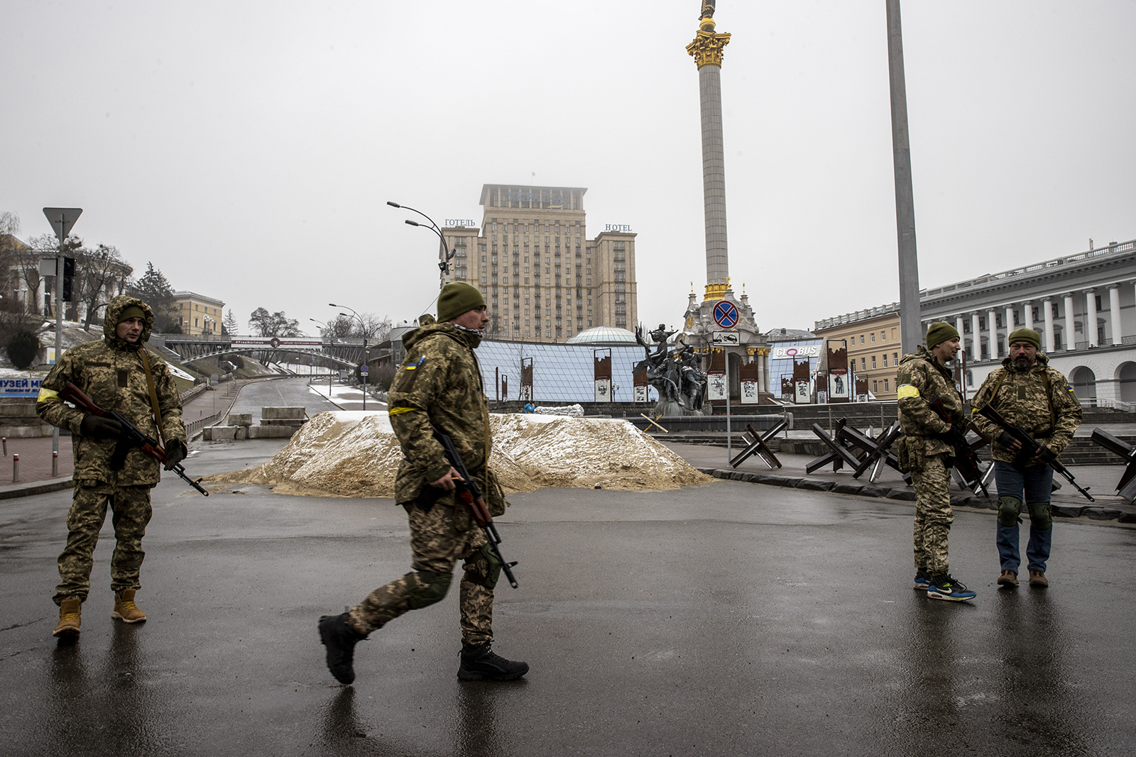 Soldiers are seen around piles of sand used for blocking a road in the Ukrainian capital of Kyiv on March 2.