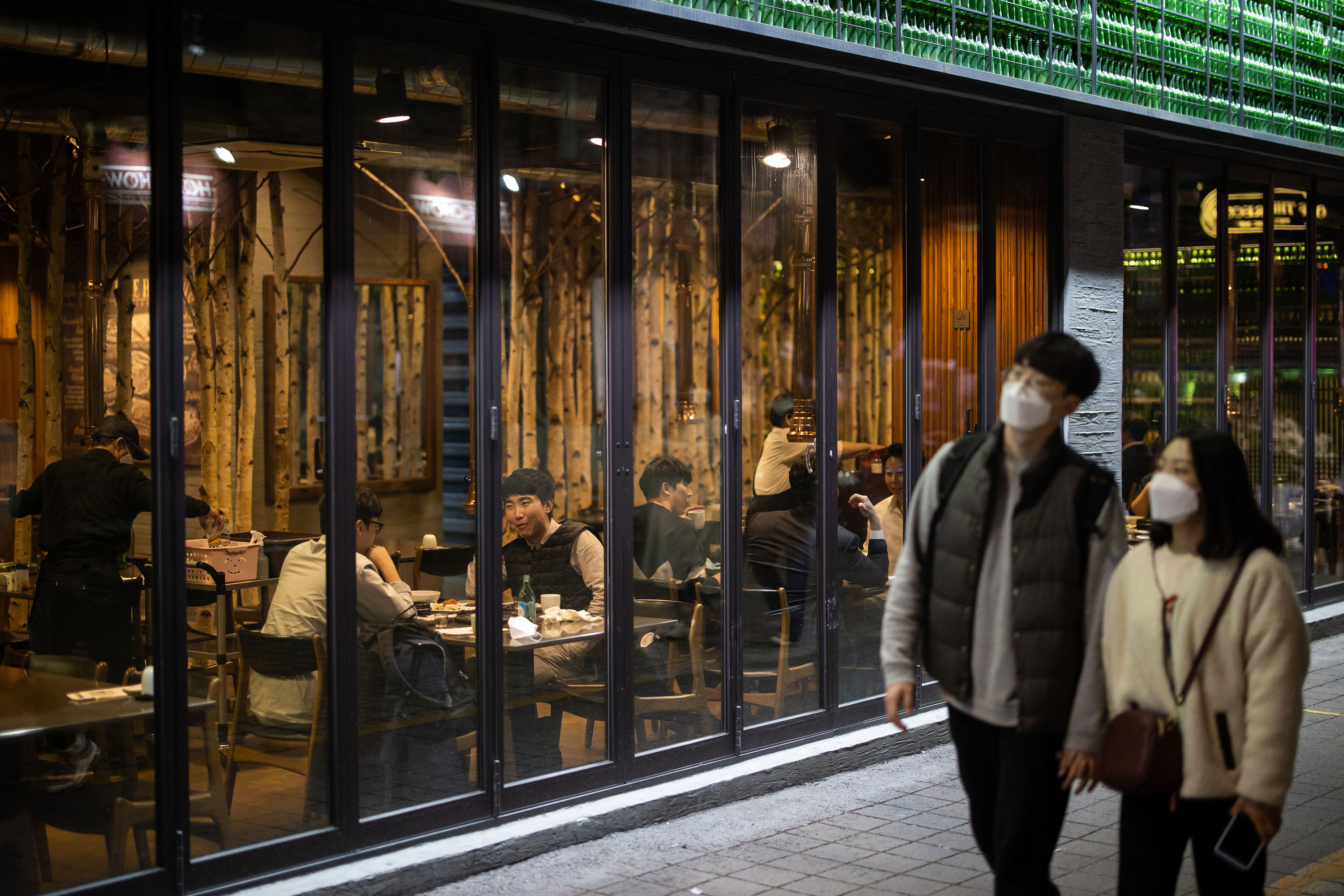 People walk past a restaurant in the Itaewon district in Seoul, South Korea, on April 24.