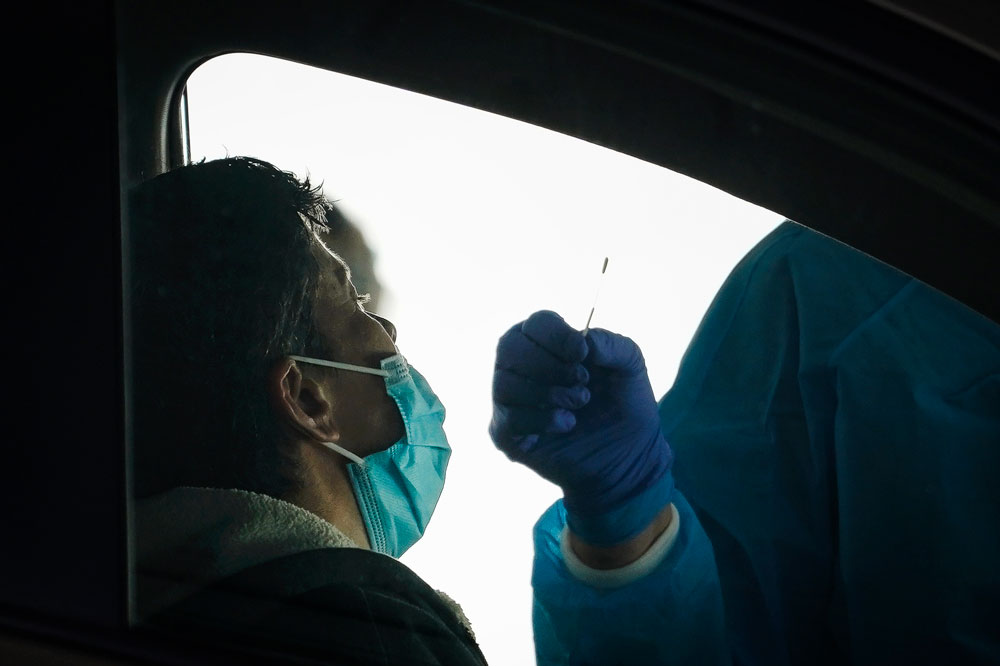 A medical professional administers a coronavirus test at a drive-thru coronavirus testing site run by George Washington University Hospital on April 6, in Washington.