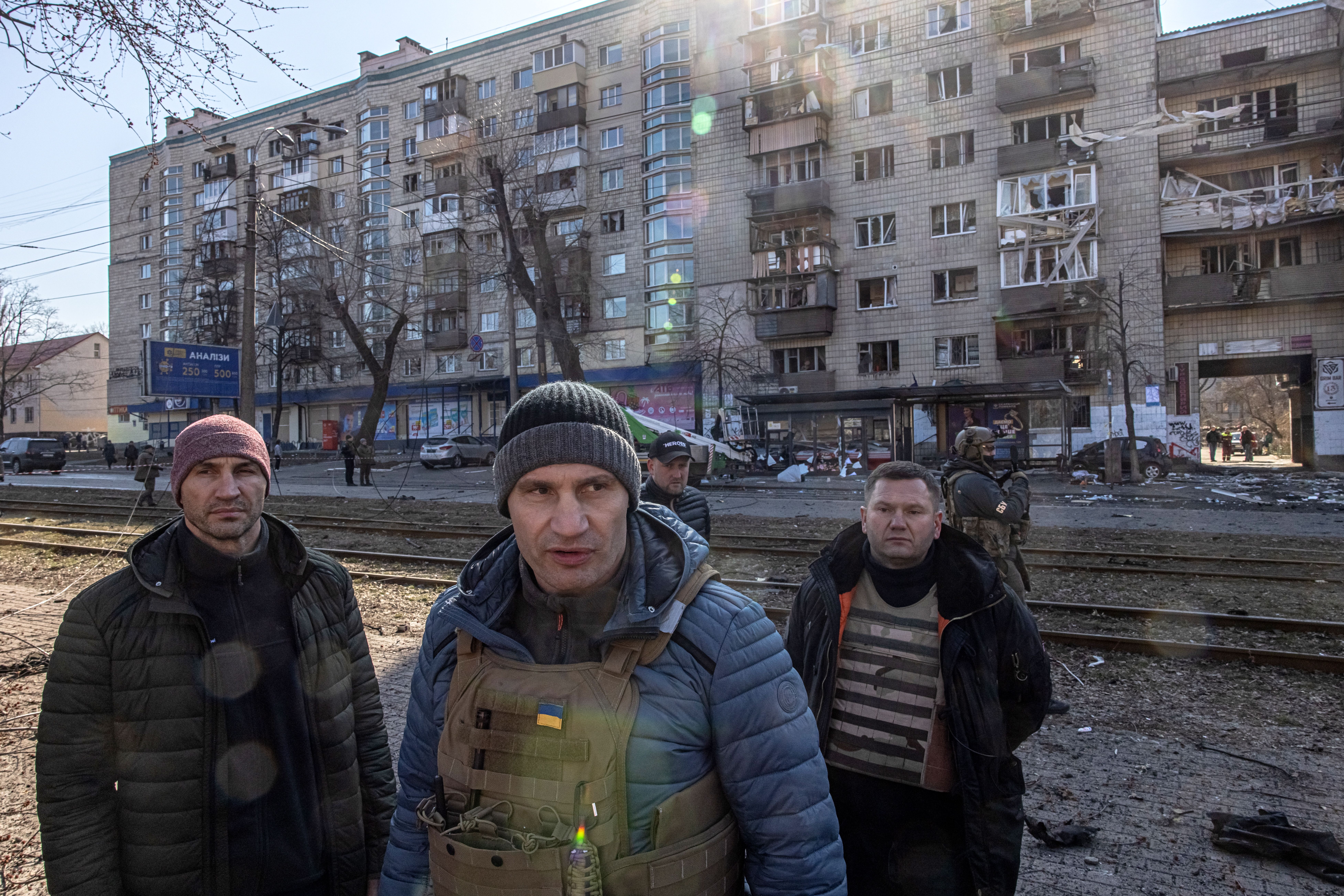 Kyiv's Mayor Vitaly Klitschko (C) and his brother Vladimir Klitschko (L) visit a residential area after shelling in Kyiv, Ukraine, on 14 March.