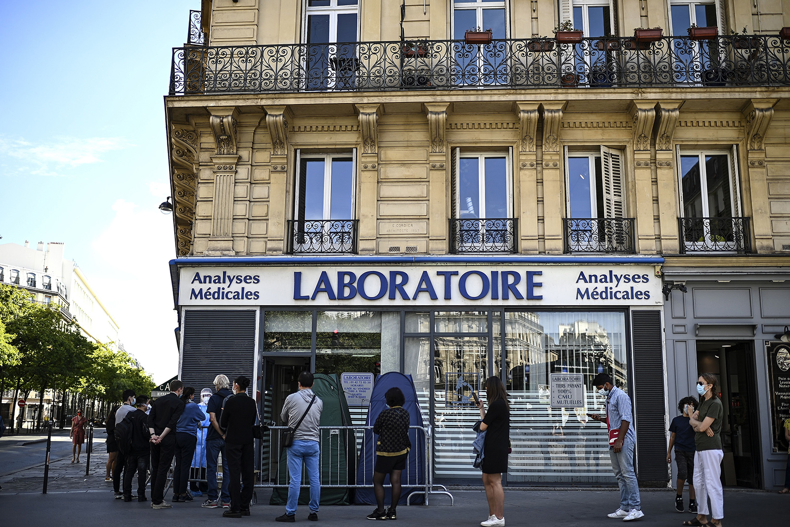People stand in a queue as they wait for a PCR test for the novel coronavirus at a medical laboratory in Paris amids the Covid-19 pandemic on September 4.