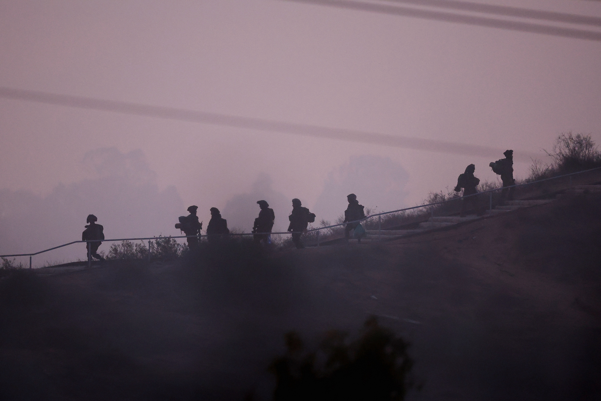 IDF soldiers move along the border with Gaza on Thursday.