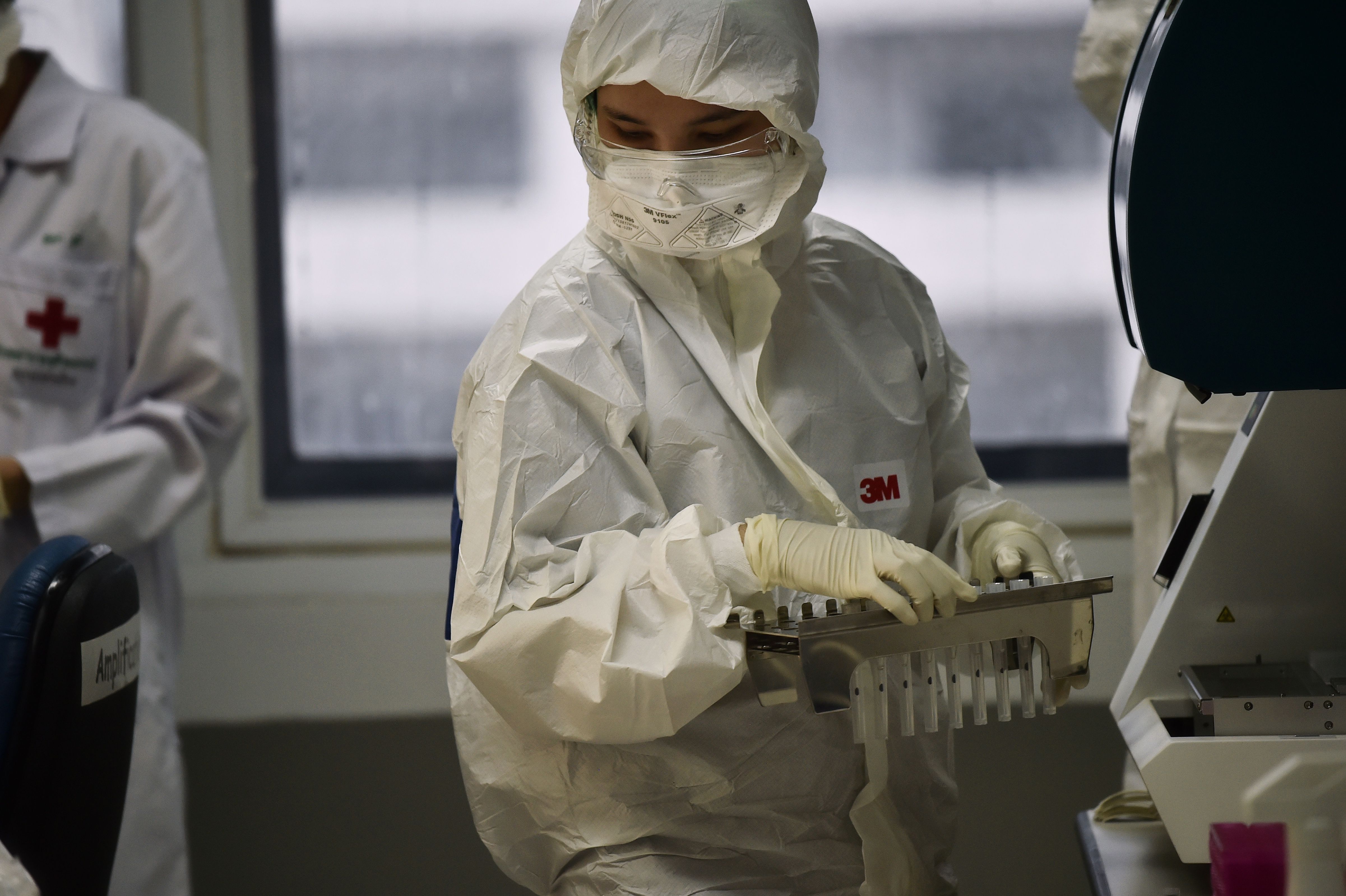 A lab technician tests coronavirus patient samples at Chulalongkorn University in Bangkok, Thailand on Wednesday.