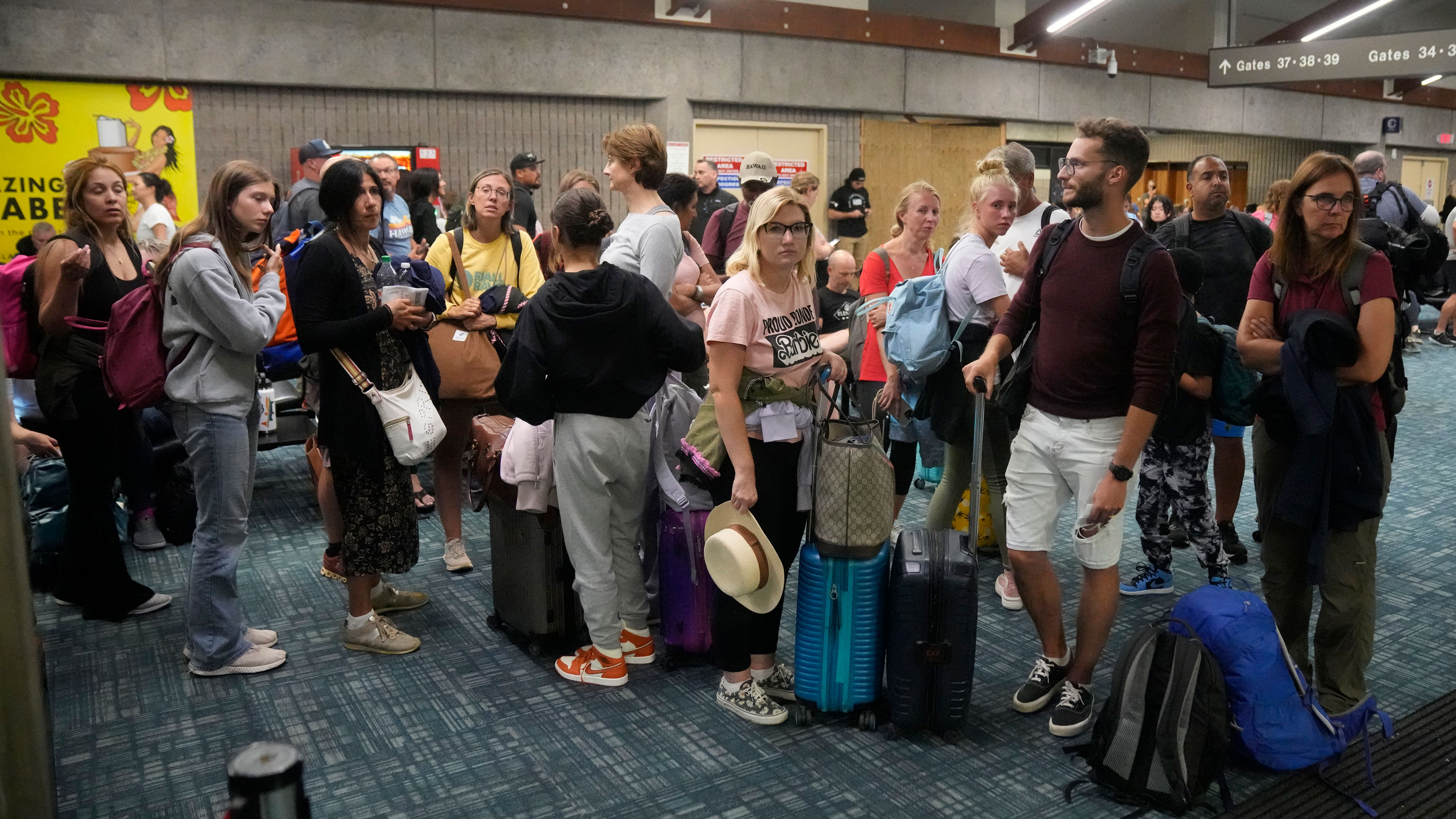 People gather while waiting for flights at the Kahului Airport in Kahului, Hawaii on August 9.