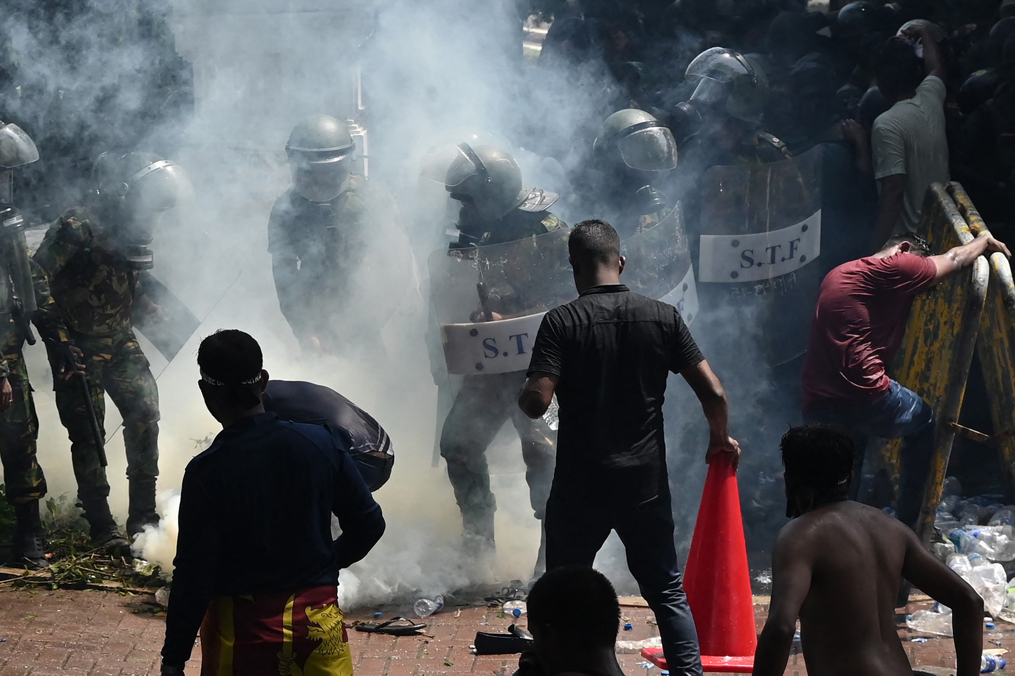Army personnel use tear gas to disperse demonstrators during an anti-government protest outside the office of Sri Lanka's prime minister in Colombo on July 13.