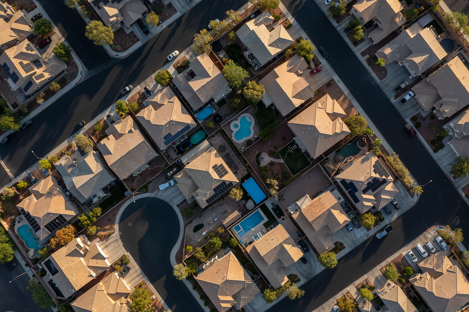 Swimming pools sit in the backyards of homes in a residential neighborhood in Henderson, Nevada, in July 2021.