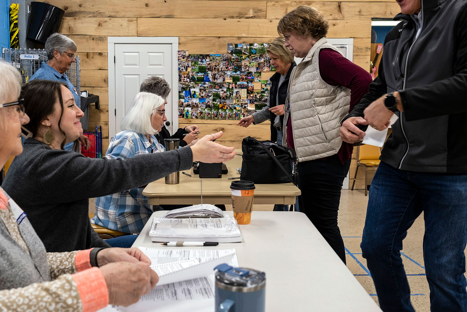 Voters are greeted by poll workers as they arrive to cast their ballots in Pella, Iowa.