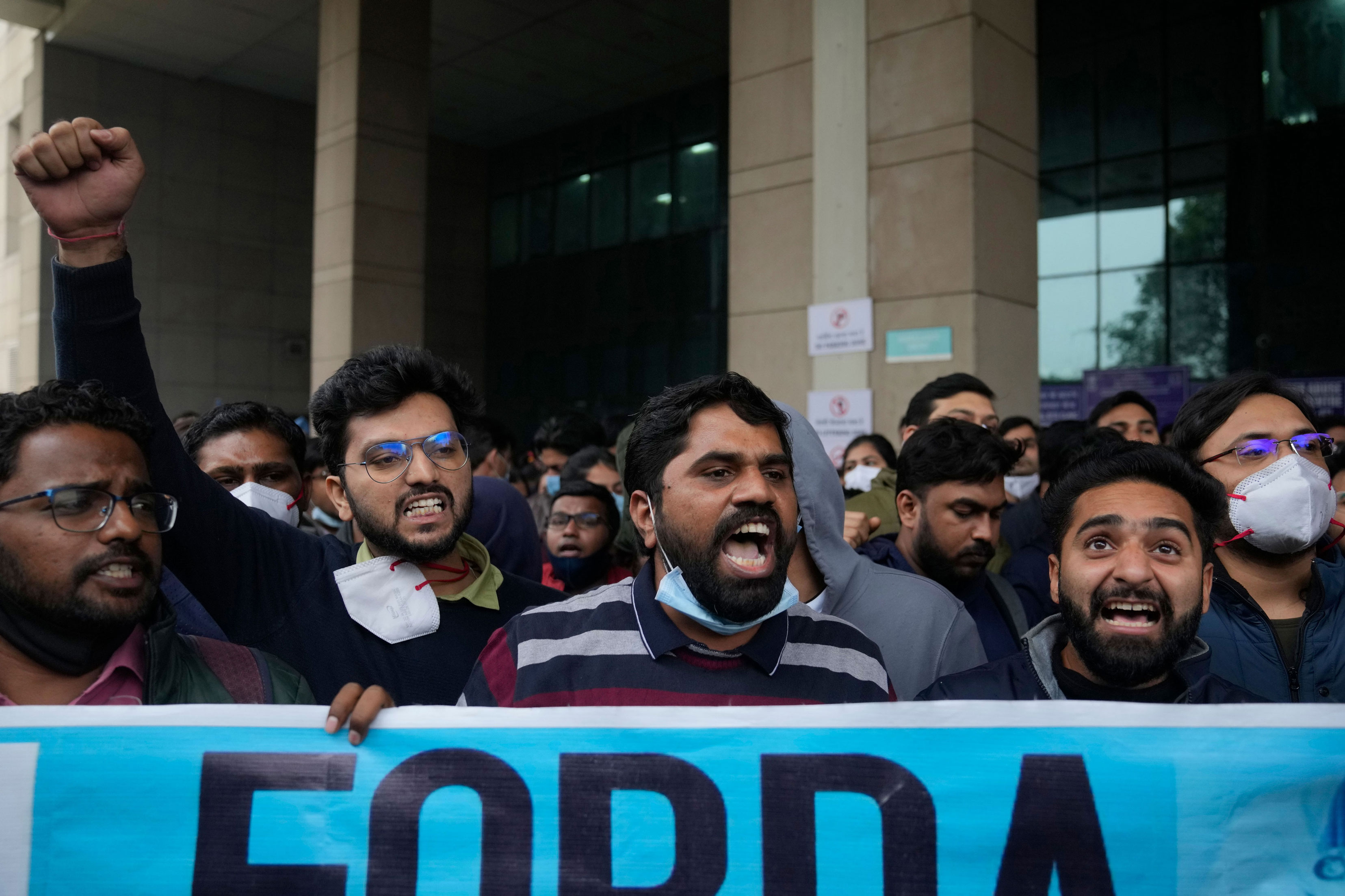 Junior doctors of a government medical college hospital shout anti-government slogans as they march in New Delhi on Tuesday.