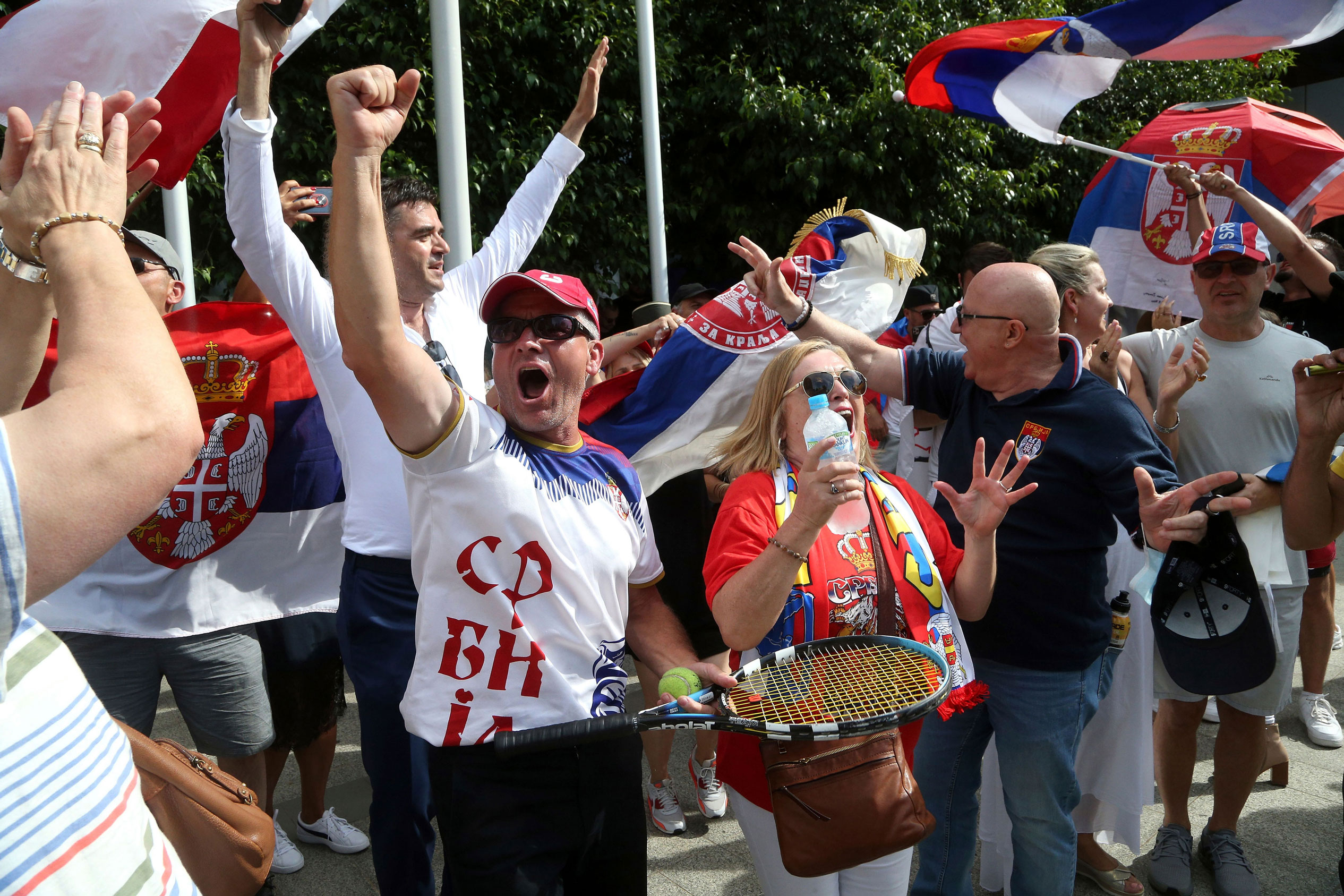 Fans of Serbian tennis star Novak Djokovic react to news of his overturned ruling outside Federal Court ahead of the Australian Open in Melbourne, Australia, Monday.