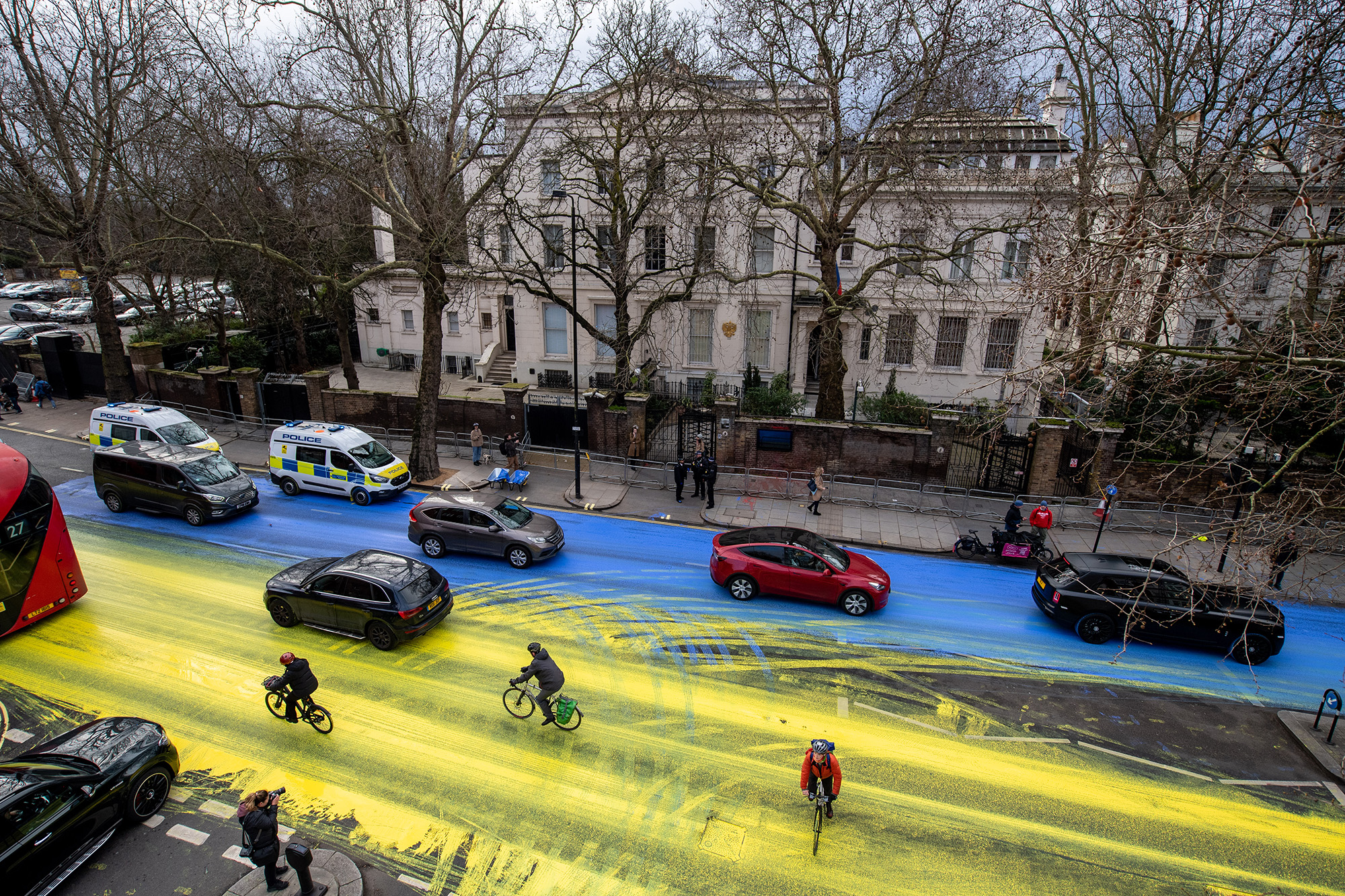 Activists from political campaign group Led By Donkeys poured paint onto the road to create a giant Ukrainian flag outside the Russian Embassy in London on February 23.