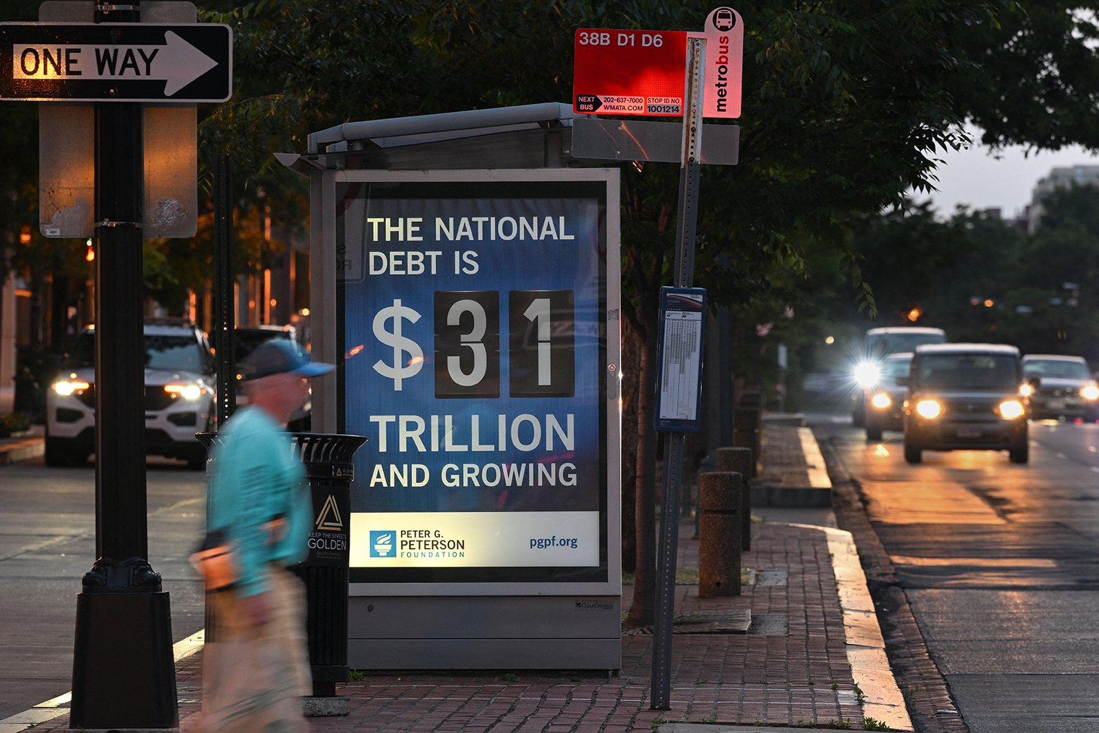 A poster at a bus shelter shows the national debt in Washington, DC, on May 21. 