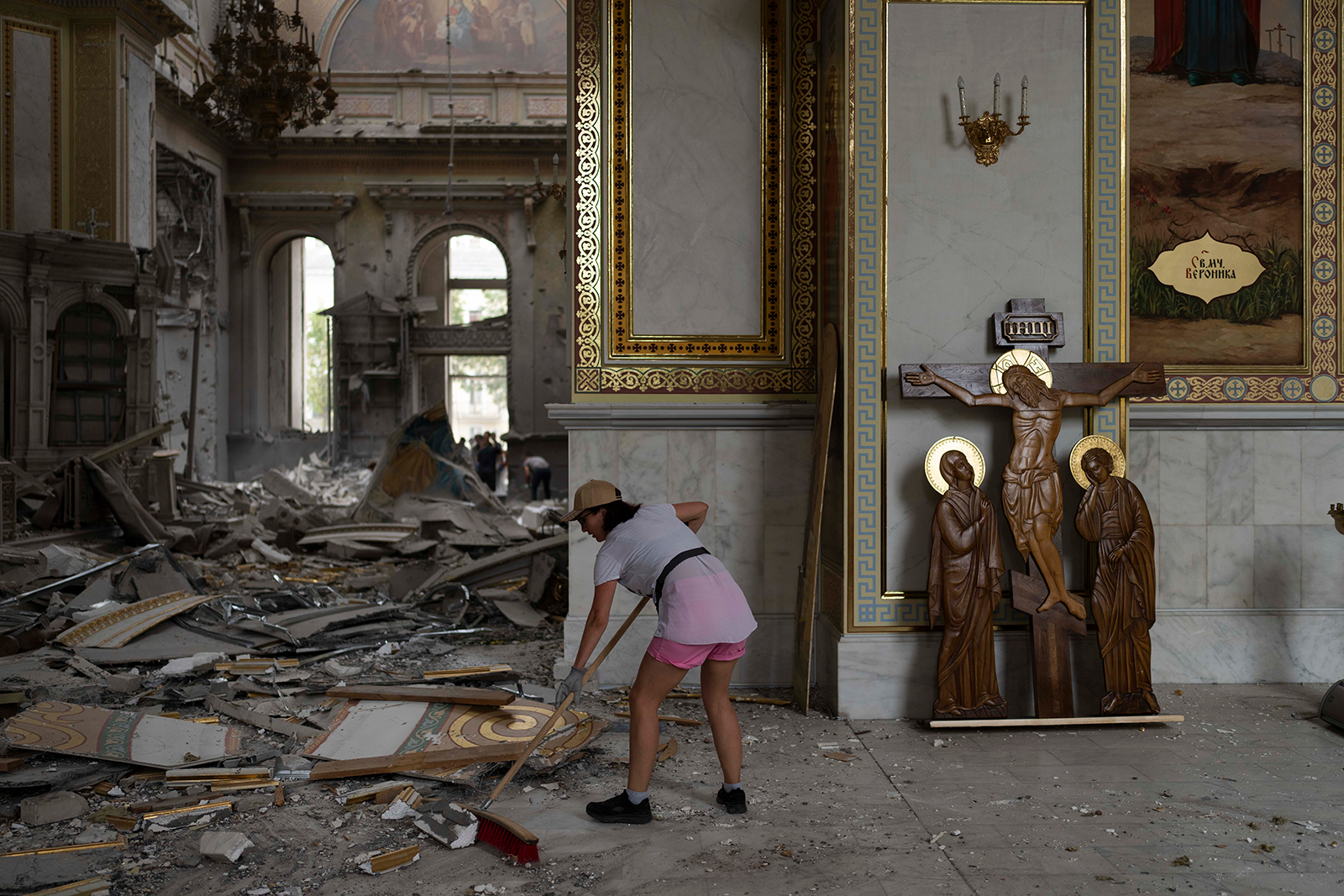 A woman helps clean up the Transfiguration Cathedral in Odesa, Ukraine, on July 23. 