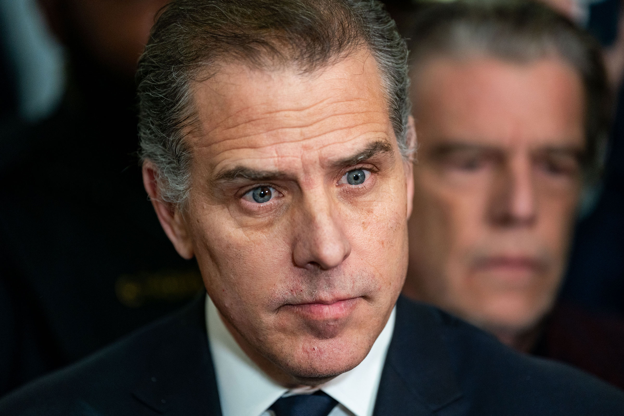 Hunter Biden listens as his lawyer Abbe Lowell speaks to the press outside a House Oversight Committee meeting on January 10, in Washington, DC.