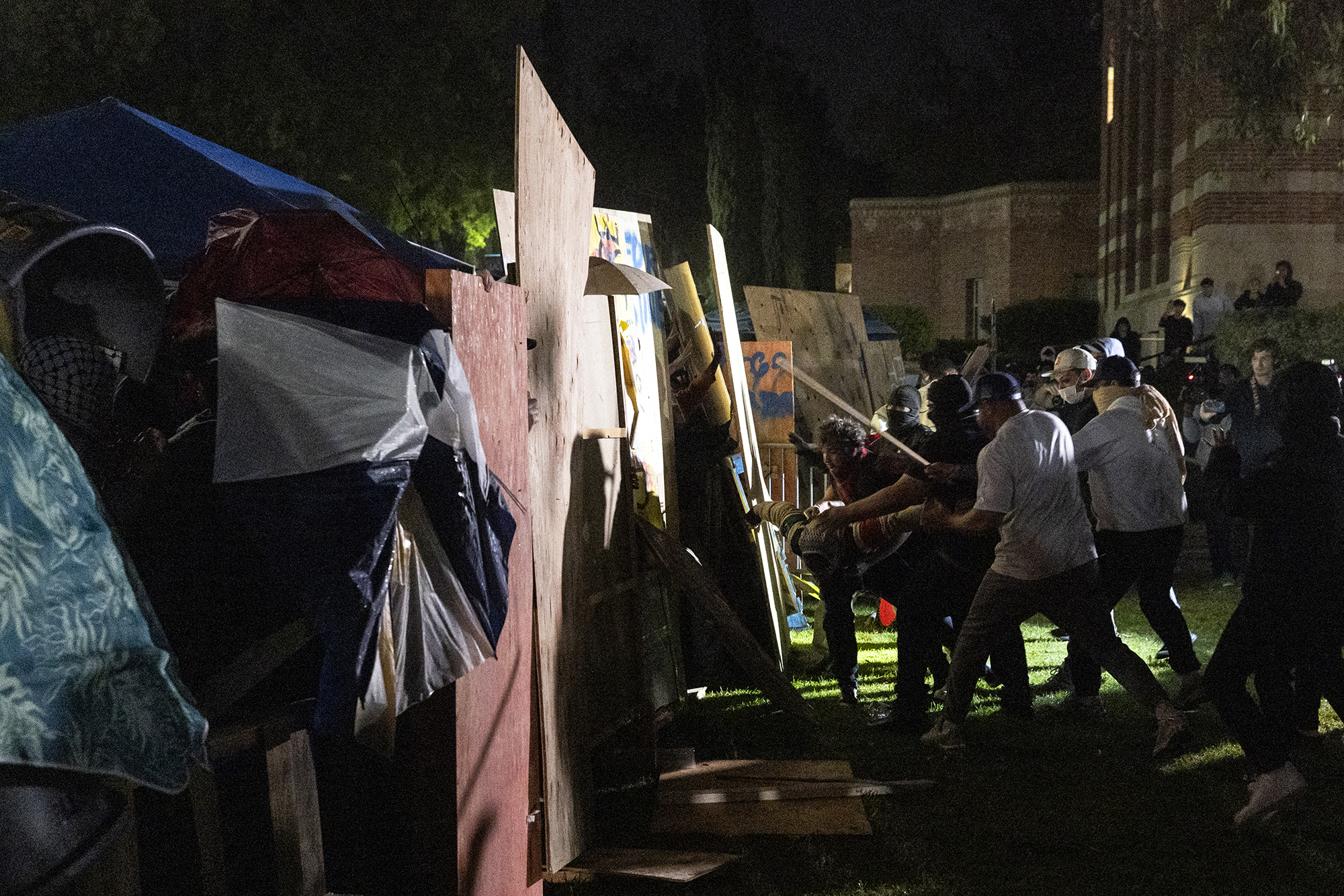 Counter protesters confront a pro-Palestinian encampment set up on the campus of the University of California Los Angeles (UCLA) as clashes erupt, in Los Angeles on May 1.