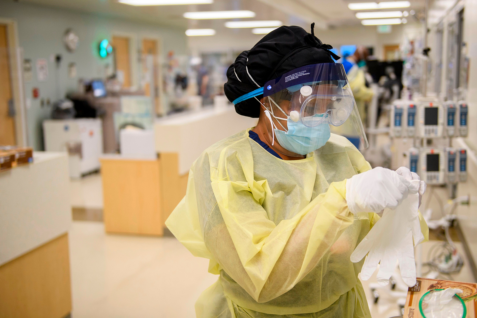 A nurse dons personal protective equipment to attend to patients in a Covid-19 intensive care unit at Martin Luther King Jr. Community Hospital on January 6, in the Willowbrook neighborhood of Los Angeles.
