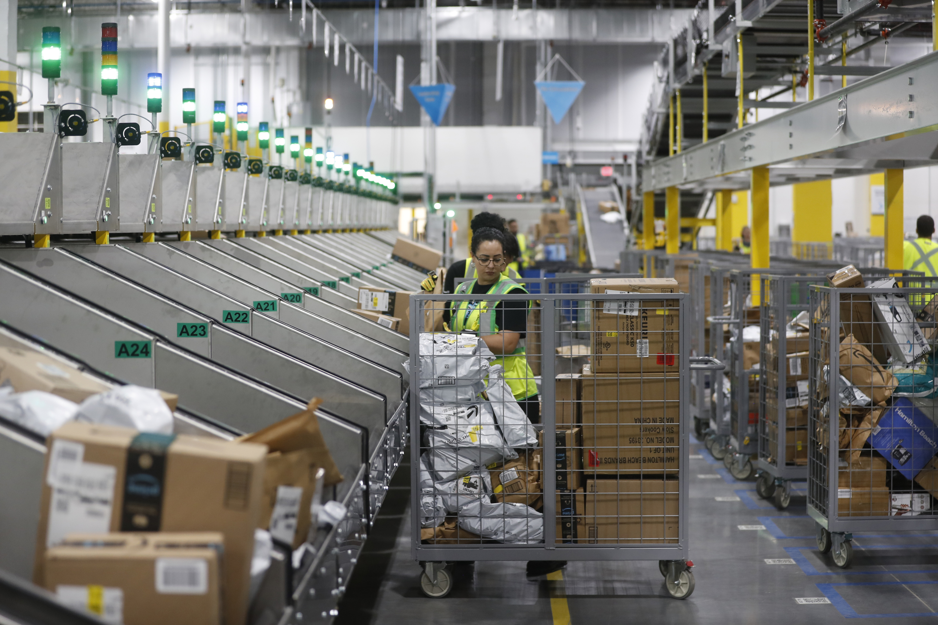 Amazon associates work to ship out orders during Cyber Monday at the Same-Day Delivery Facility Fulfillment Center on November 27, in Tampa, Florida.