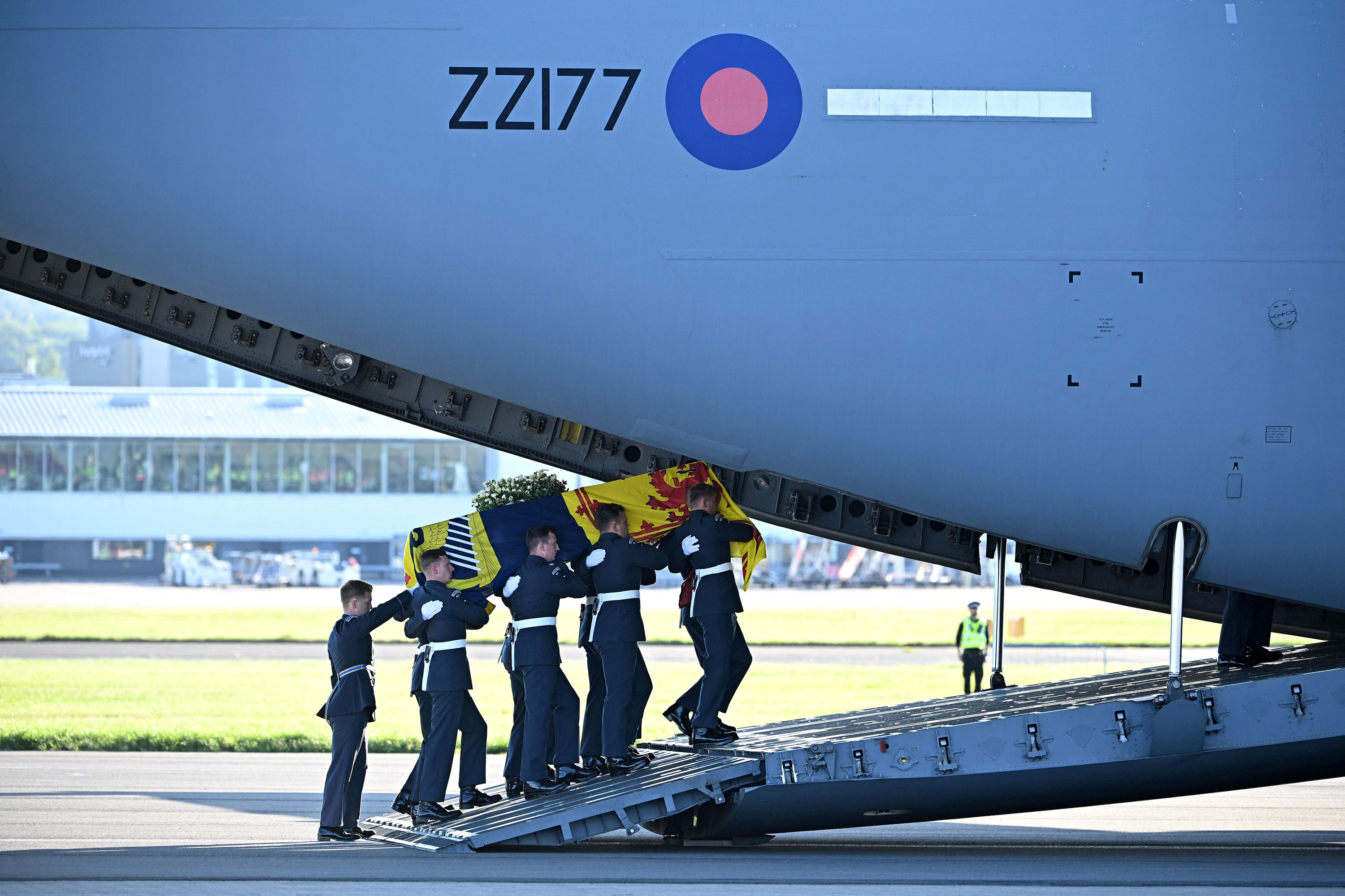 Pallbearers from the Queen's Colour Squadron of the Royal Air Force carry the coffin of Queen Elizabeth into a RAF-C17 aircraft at Edinburgh airport on Tuesday.