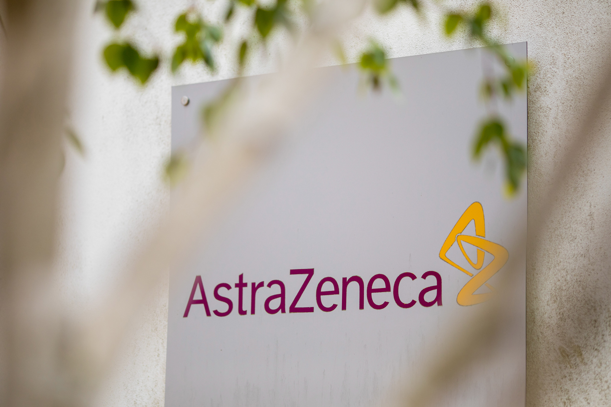 A sign featuring the AstraZeneca logo stands at the company's DaVinci building at the Melbourn Science Park in Cambridge, U.K., on June 8.