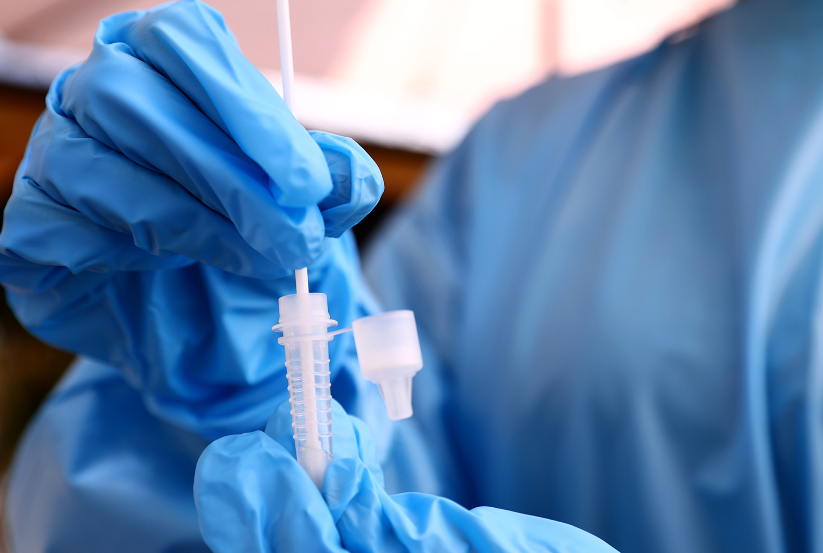 A registered nurse stirs a nasal swab in testing solution after administering a Covid-19 test on July 14 in Los Angeles.