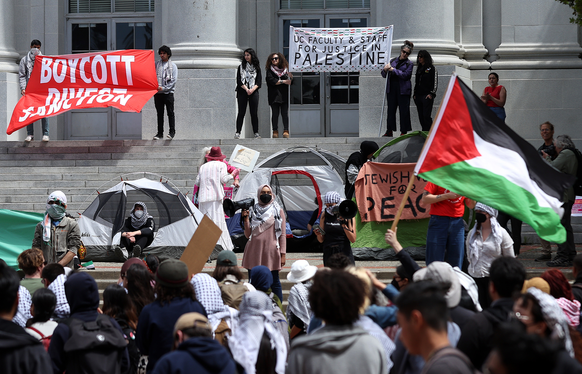Pro-Palestinian protesters set up a tent encampment during a demonstration in front of Sproul Hall on the UC Berkeley campus on April 22, 2024 in Berkeley, California. Hundreds of pro-Palestinian protesters staged a demonstration in front of Sproul Hall on the UC Berkeley campus where they set up a tent encampment in solidarity with protesters at Columbia University who are demanding a permanent cease fire in war between Israel and Gaza. 