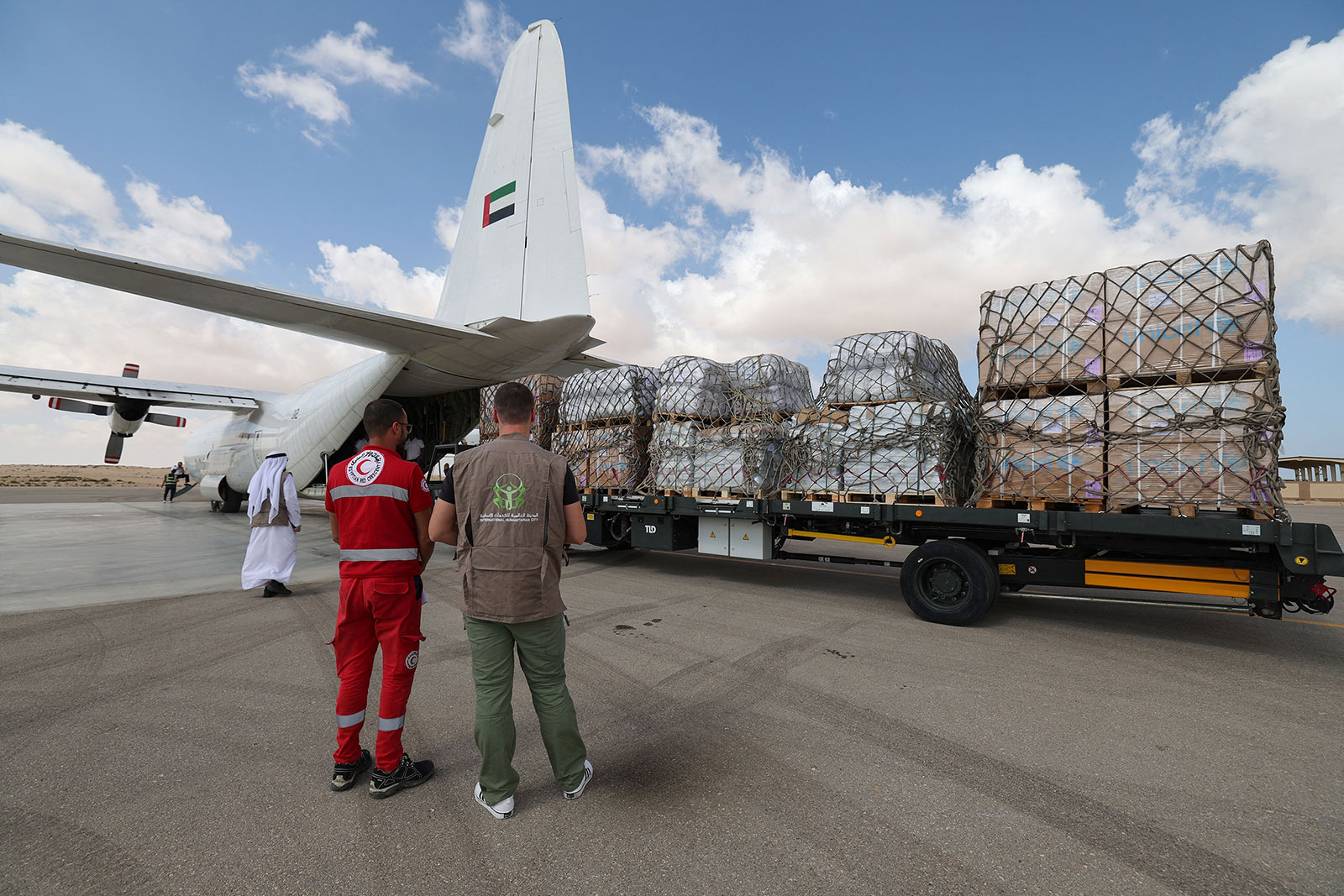 Staff members unload aid supplies meant Gaza from an Emirates cargo plane on the tarmac of Egypt's el-Arish airport on Thursday, October 19, 2023.