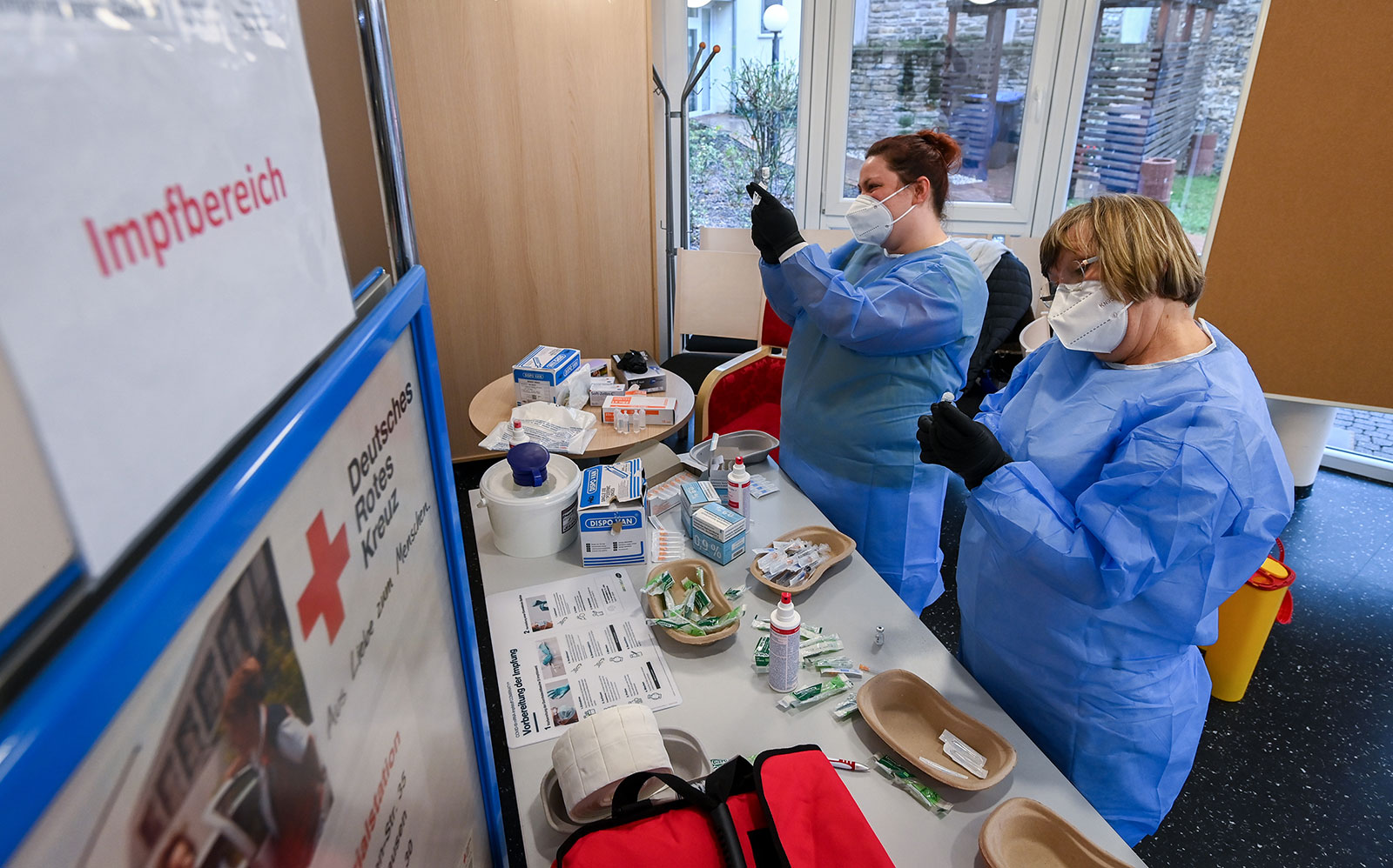 Christine Ehrenproft and Martina Neuhold prepare Covid-19 vaccines at the DRK nursing and care center in Sangerhausen, Germany, on January 13.
