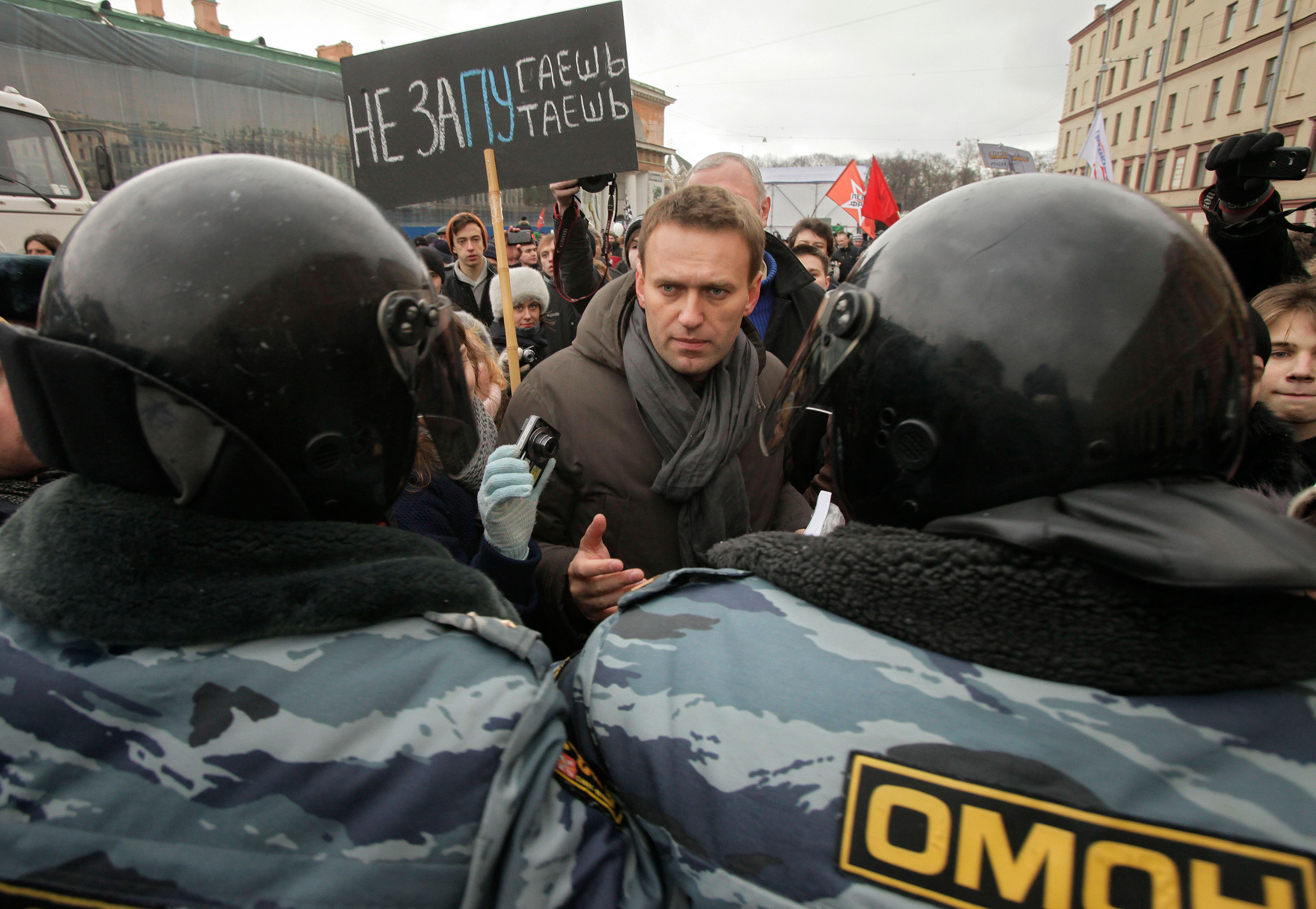 Alexey Navalny speaks with riot police officers blocking the way during a massive protest rally against Prime Minister Vladimir Putin's rule in St. Petersburg, Russia, in 2012.