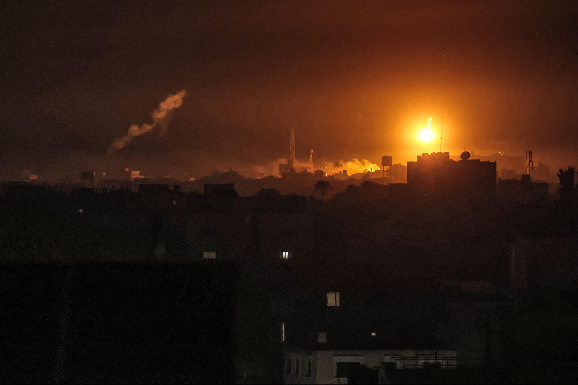 Israeli bombardment lights up the night sky over Khan Younis, Gaza, on January 7.