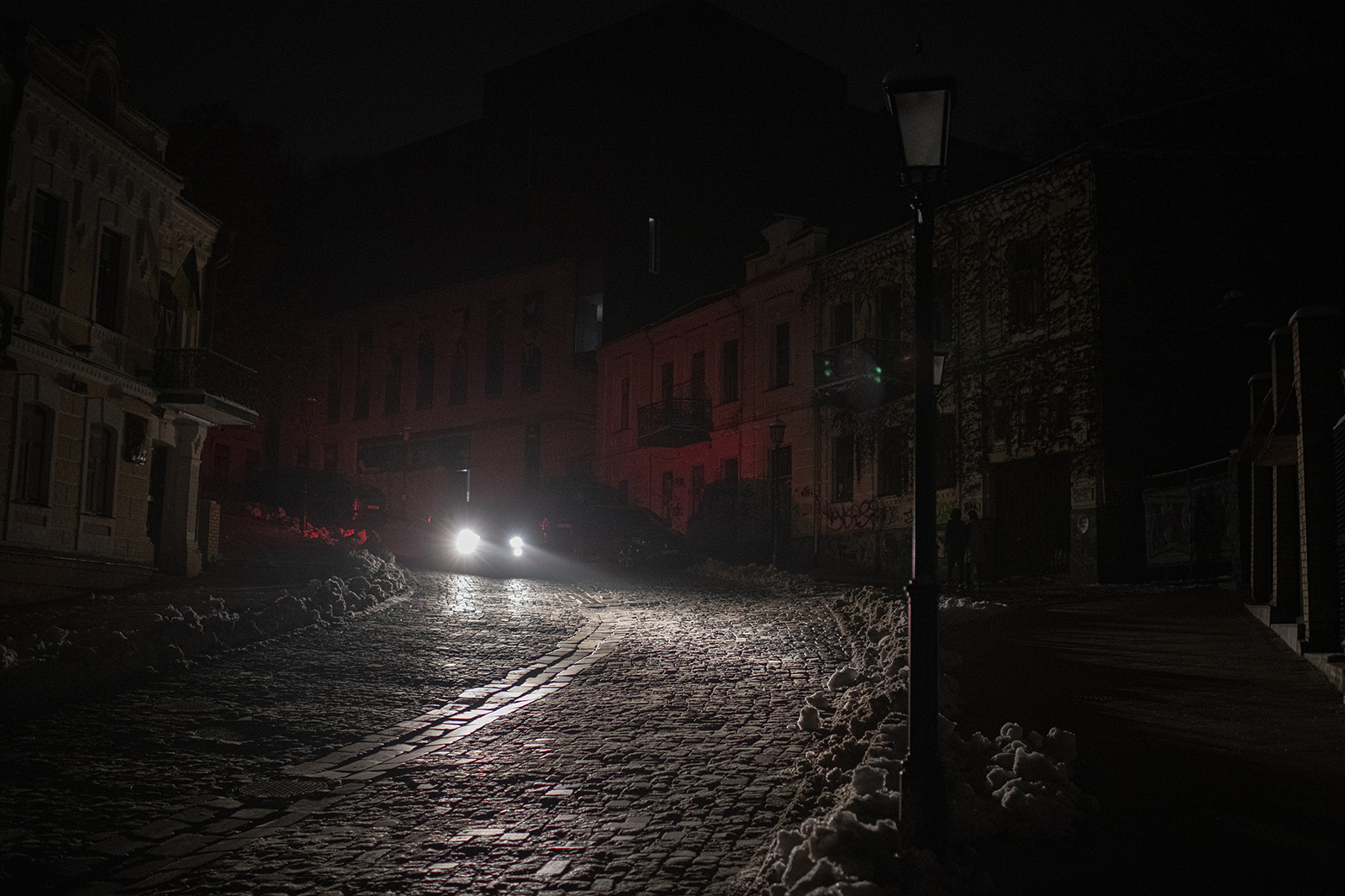 A vehicle drives past during a blackout after a Russian rocket attack in Kyiv, Ukraine, on Nov. 23.