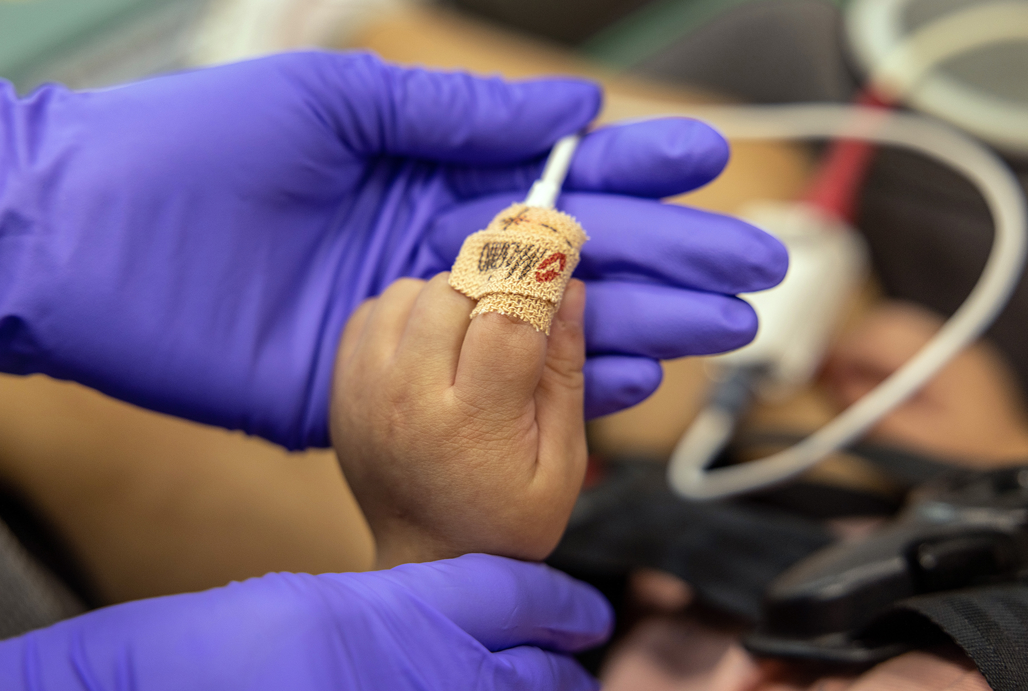 An EMS medic from the Houston Fire Department prepares to transport a Covid-19 positive girl, age 2, to a hospital on August 25, 2021 in Houston, Texas.