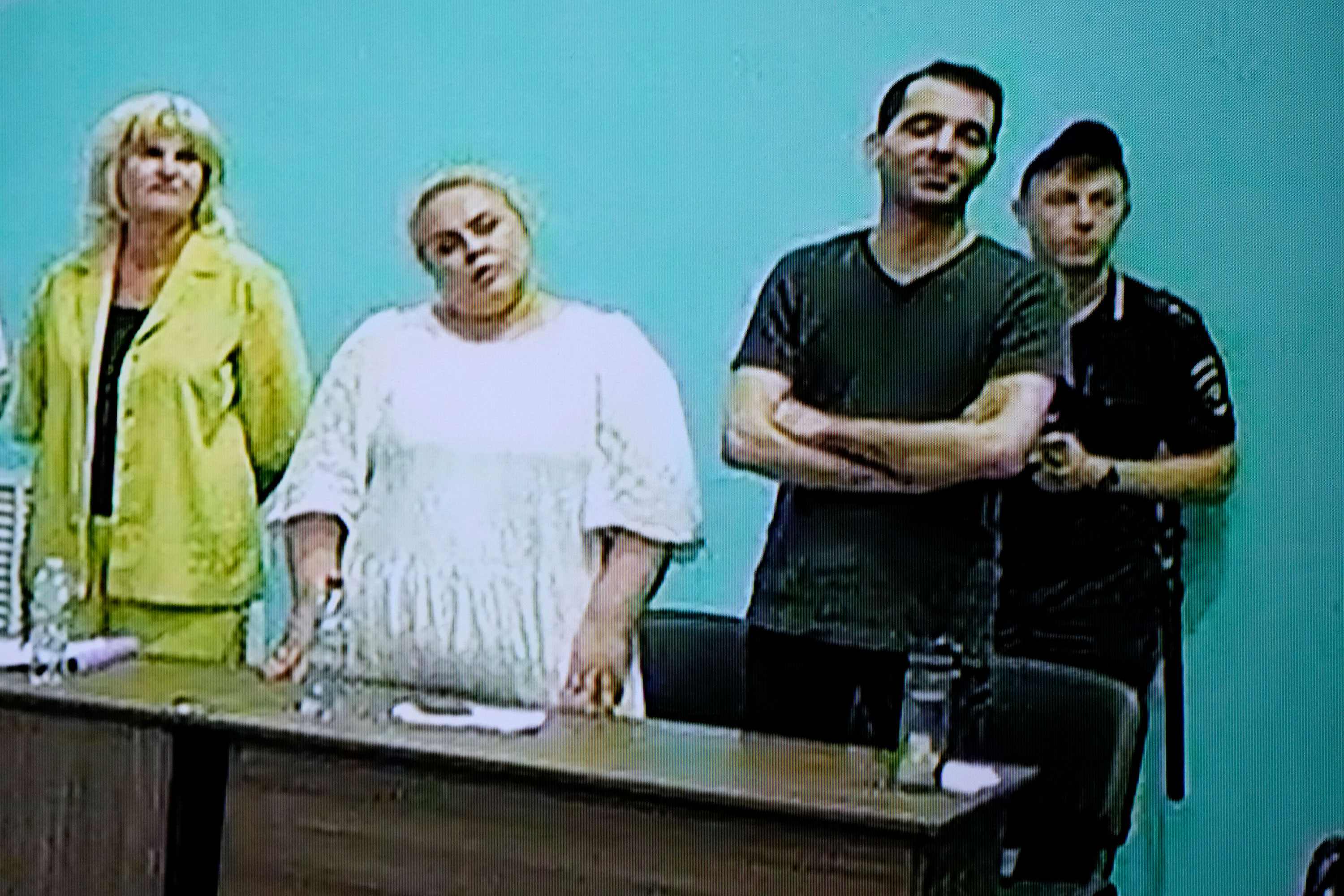 Daniel Kholodny, second from right, appears on a screen via video link during a hearing at the IK-6 penal colony in the Vladimir region, Russia, on August 4. 