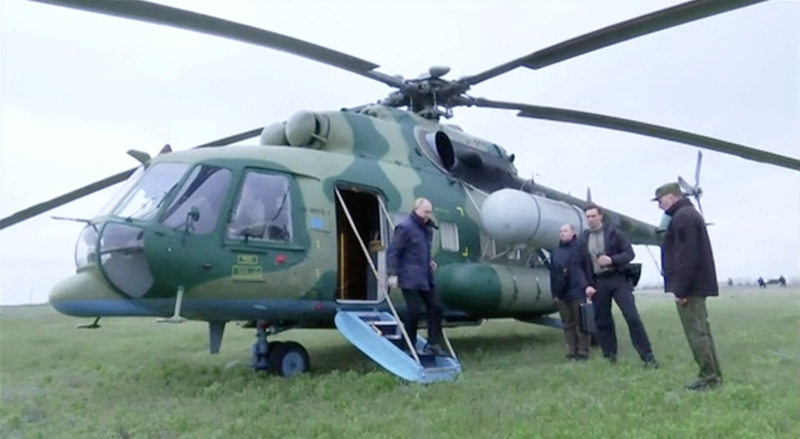 Russian President Vladimir Putin disembarks a helicopter as he visits the headquarters of the "Dnieper" army group in the Kherson Region, Ukraine, in this still image taken from handout video released on April 18, 2023. 