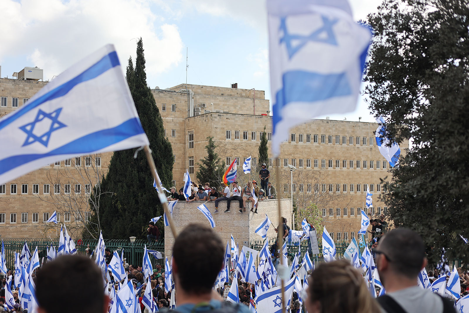Demonstrators hold Israeli flags during a protest in Jerusalem on March 27. 