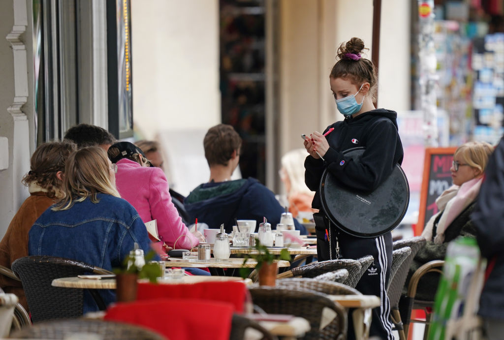A waitress takes an order at a Berlin restaurant, as cases rise across Germany.