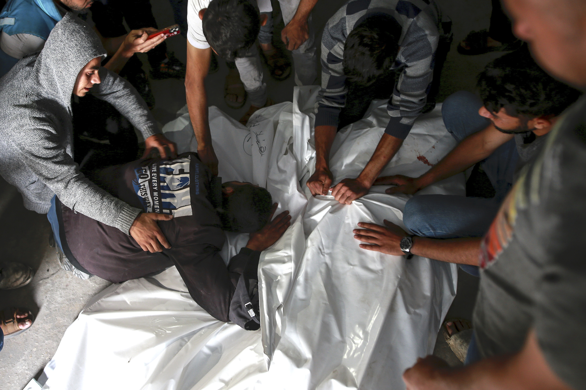 Palestinians mourn over the bodies of relatives killed in an Israeli airstrike at a morgue in Rafah on Monday.