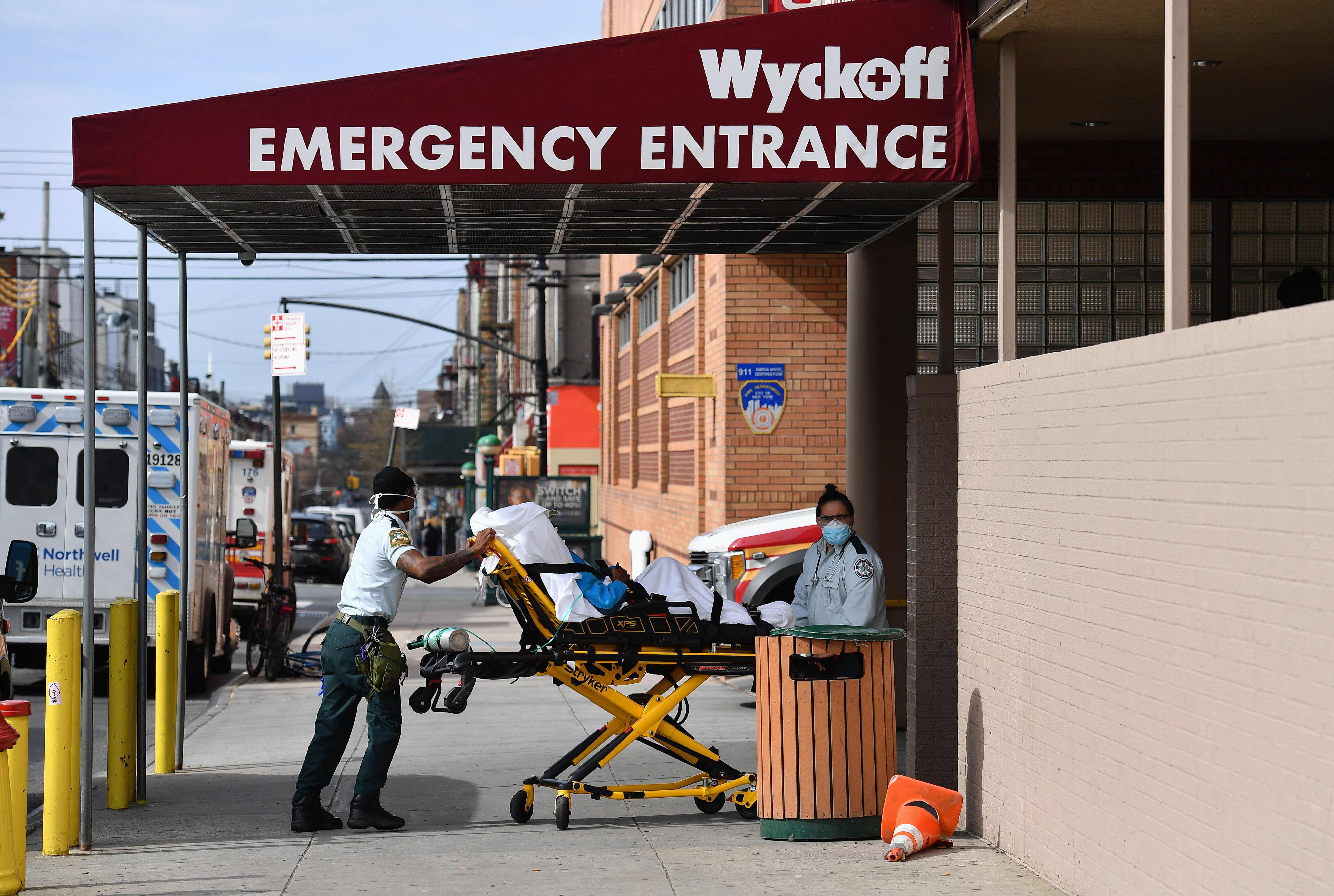 Medical staff move a patient into the Wyckoff Heights Medical Center emergency room in Brooklyn, New York, on April 7.