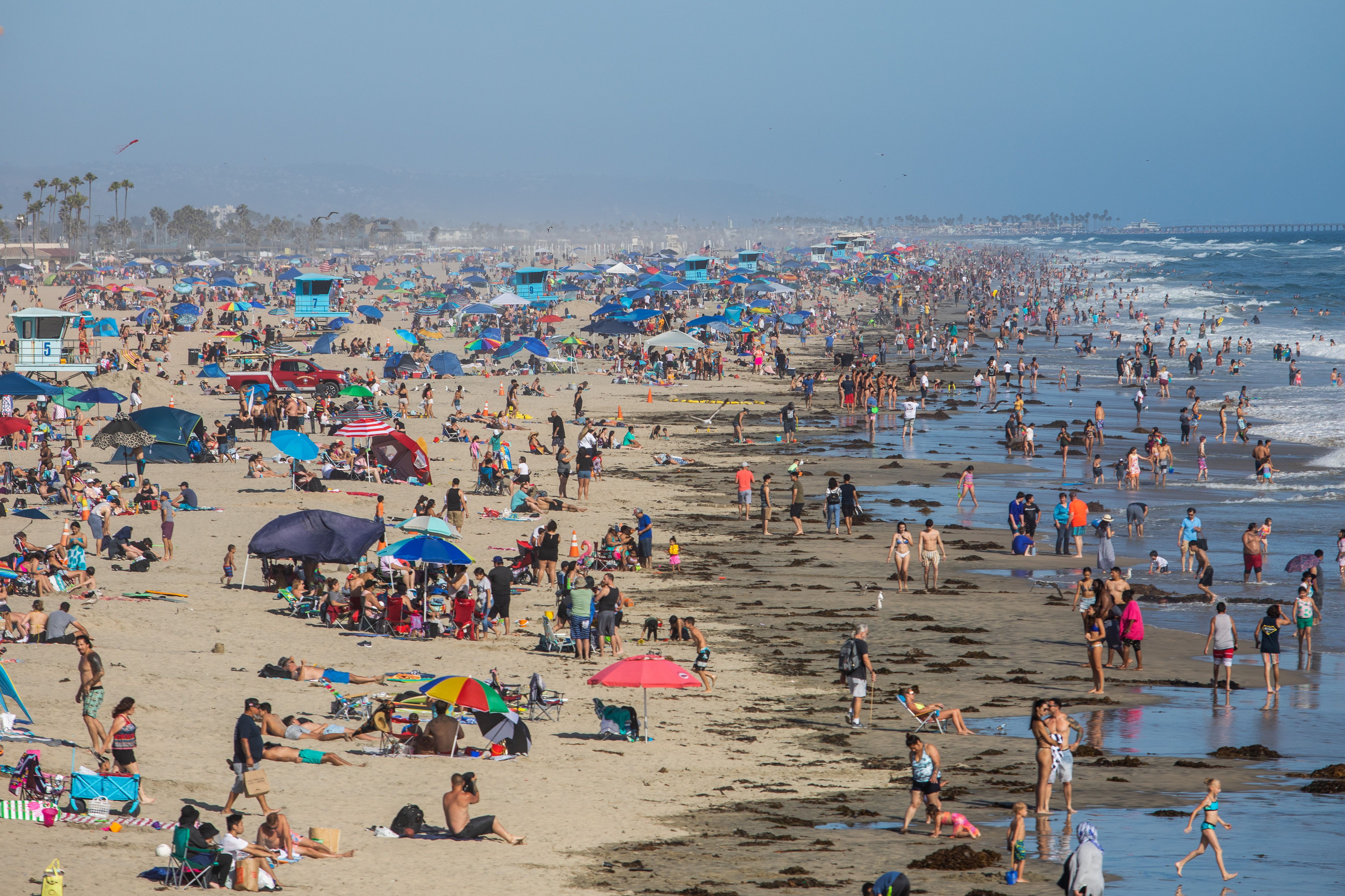 People enjoy the beach in Huntington Beach, California, on June 14.