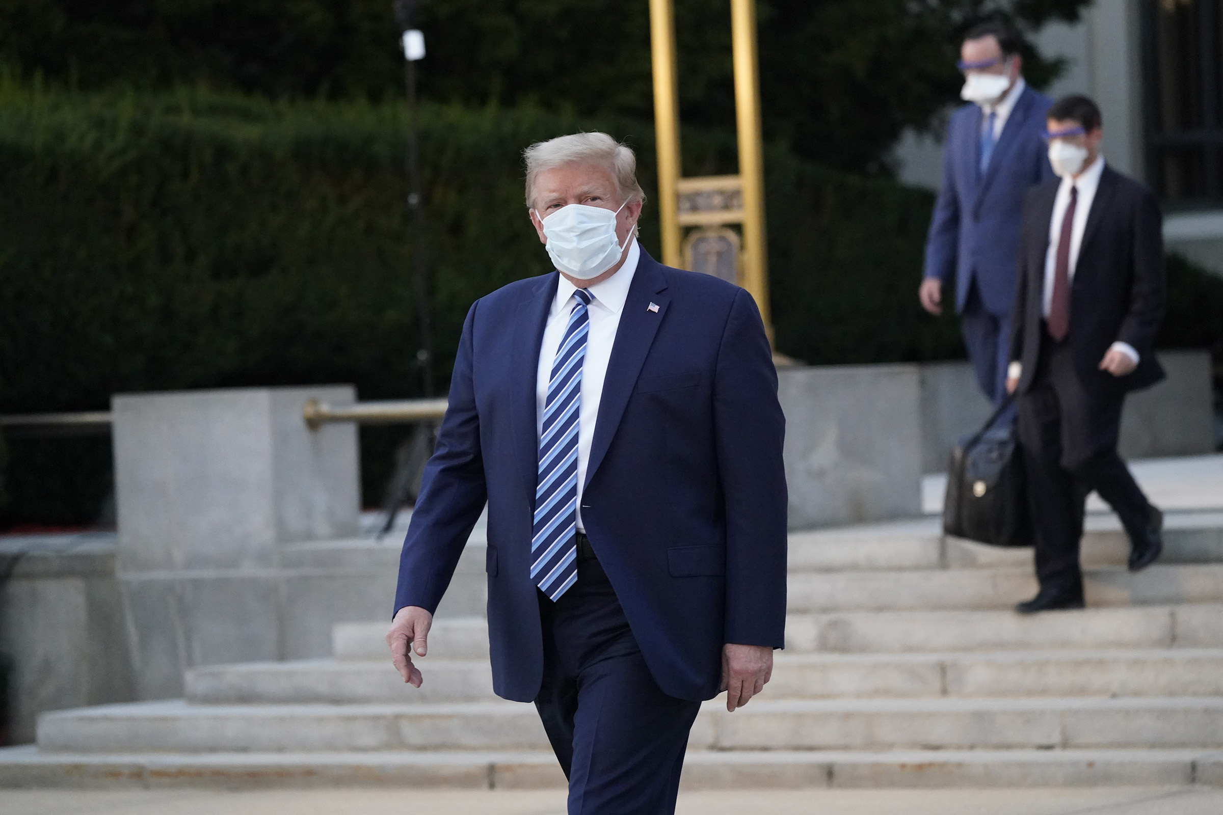 President Donald Trump walks out of Walter Reed National Military Medical Center to board Marine One in Bethesda, Maryland, on October 5, 2020. 
