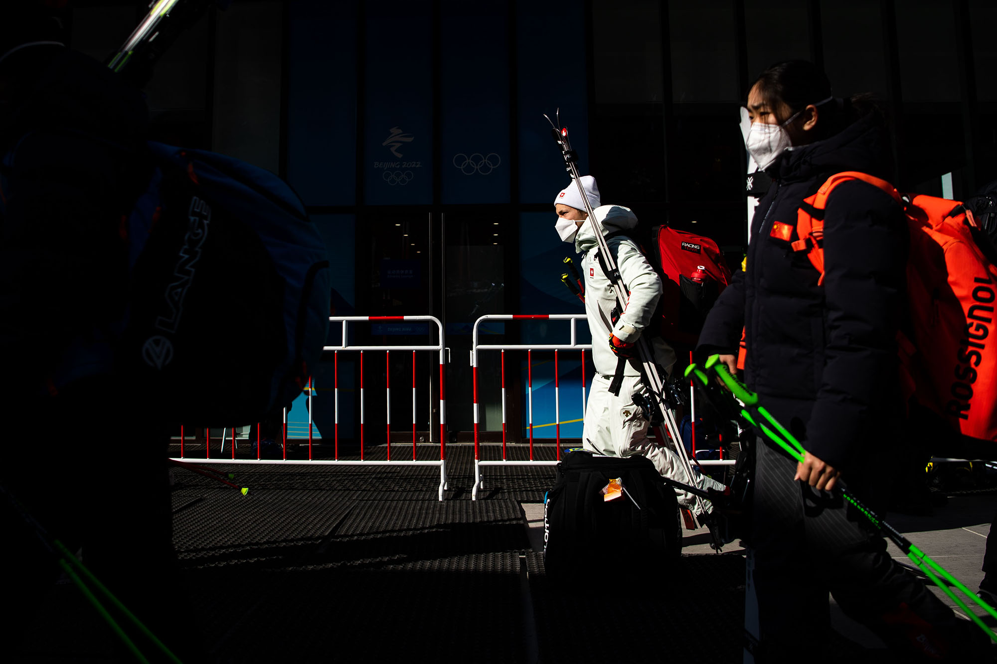 Skiers leave the Yanqing National Alpine Skiing Center after the men's downhill was postponed due to high winds on Sunday.
