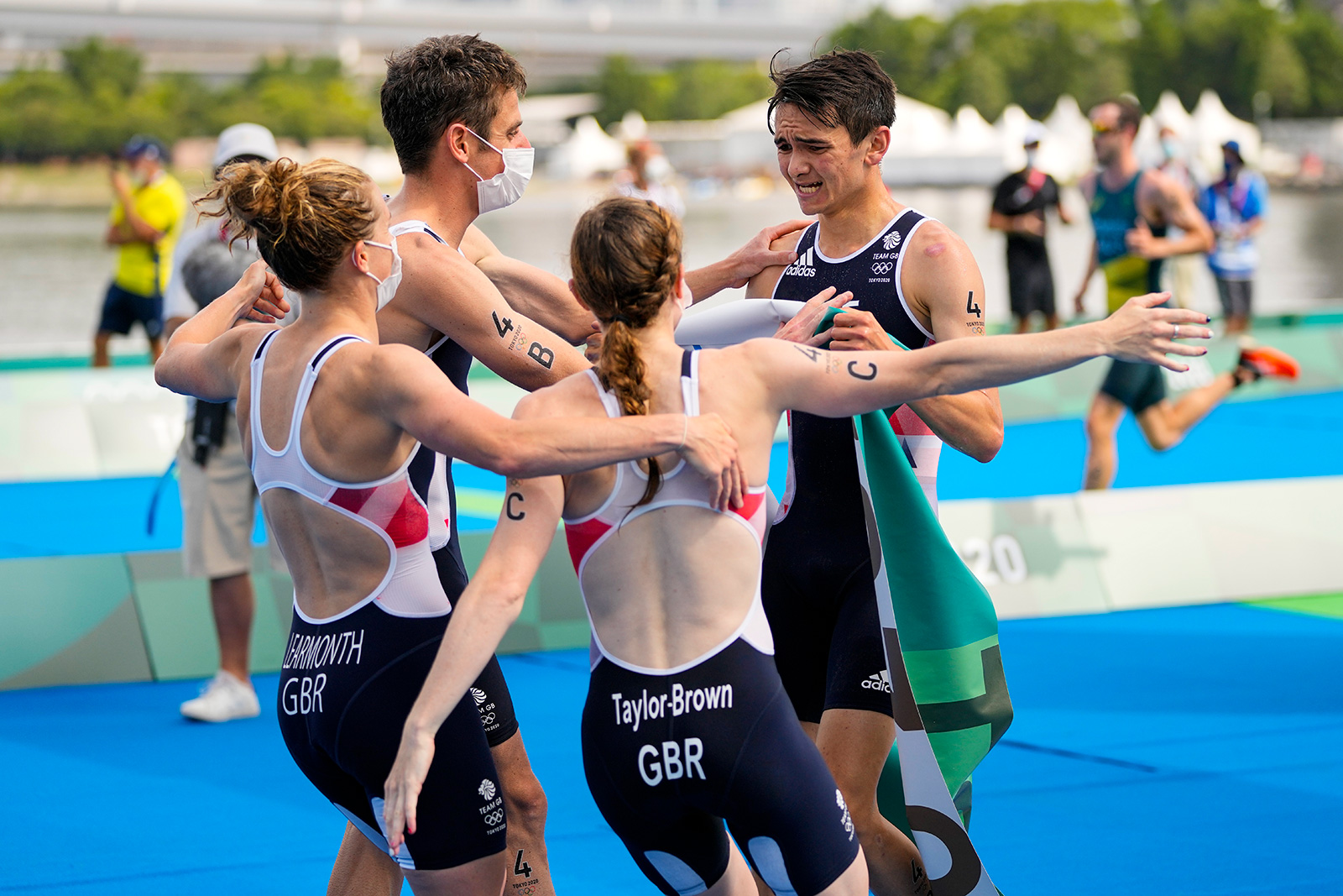 Alex Yee, Georgia Taylor-Brown, Jonny Brownlee, and Jessica Learmonth of Britain celebrate after winning the gold medal in the mixed relay triathlon on Saturday, July 31.