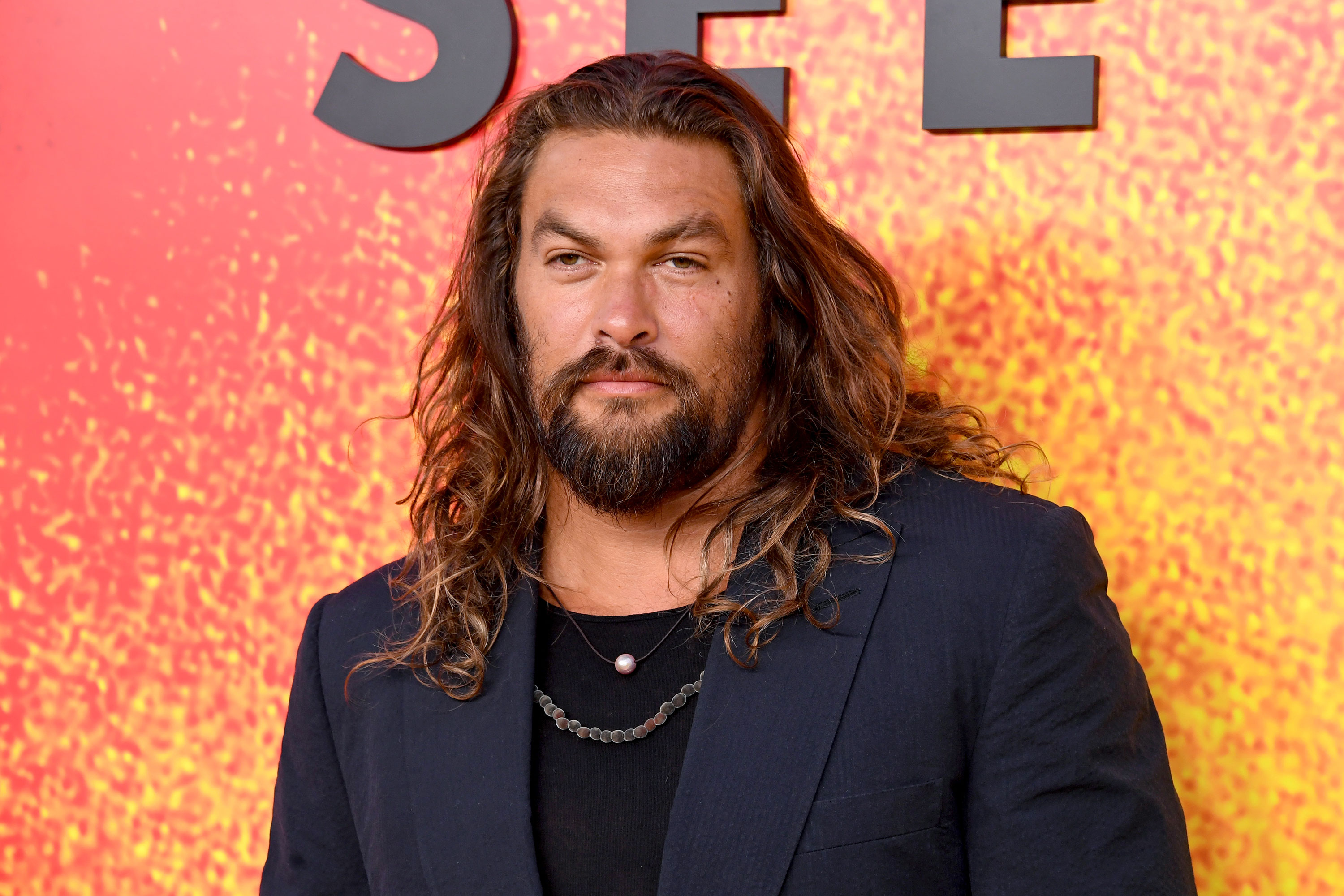 Jason Momoa poses for photos in Los Angeles in August 2022.