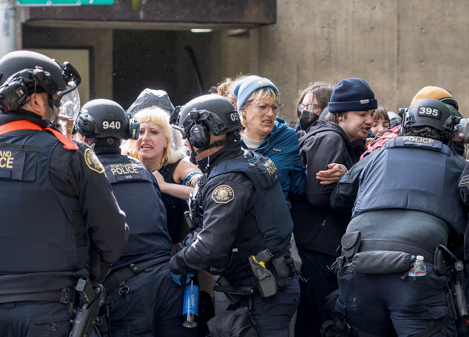 Police officers scuffle with protesters trying to block vehicles taking detained students, who had been occupying the Portland State University Library building on May 2.