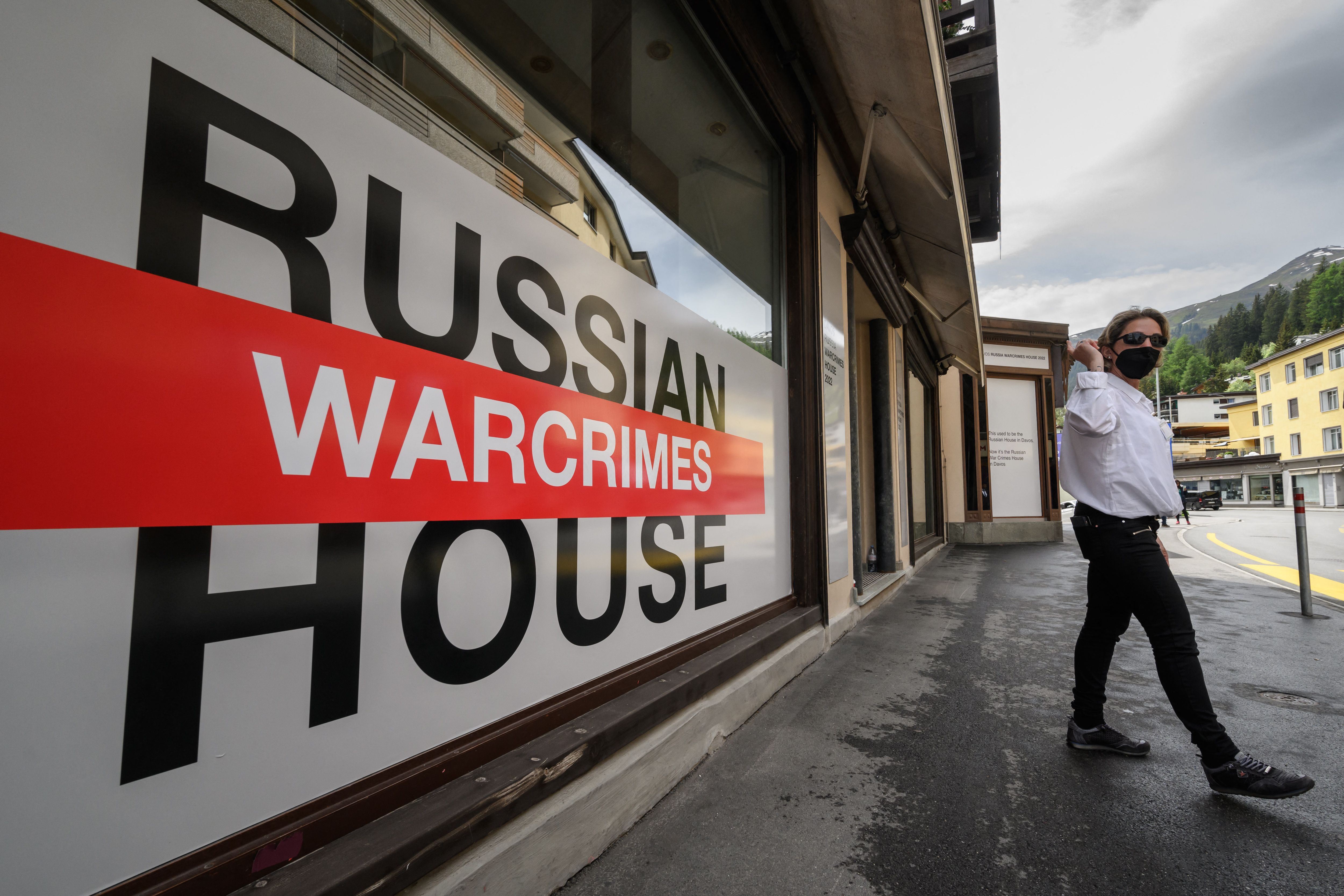 A security personnel walks next to the entrance of Russia House, now rebranded as the Russian War Crimes House, in Davos, on Sunday.