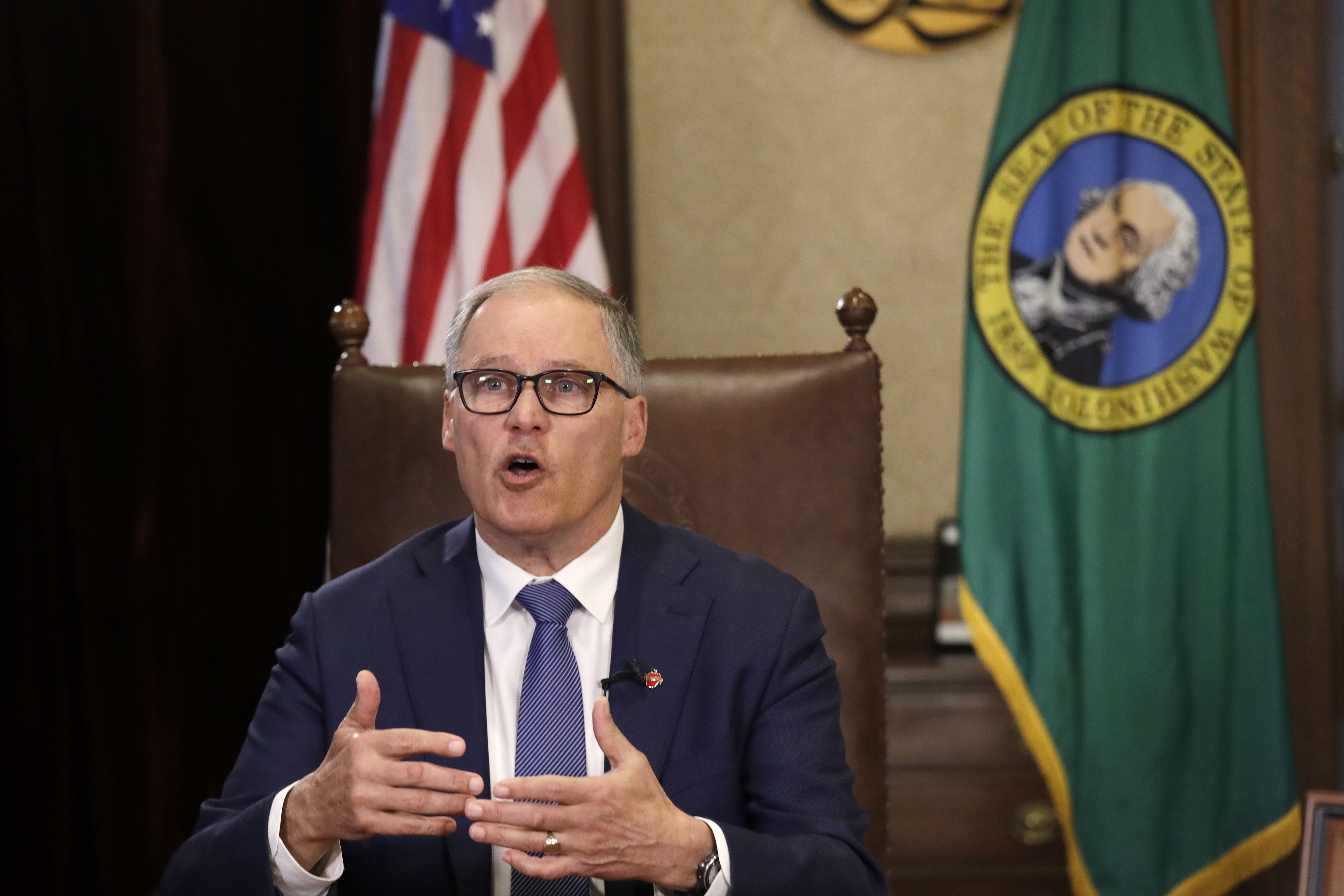 Washington Gov. Jay Inslee prepares to speak about additional plans to slow the spread of coronavirus before a televised address from his office in Olympia, Washington, on March 23.