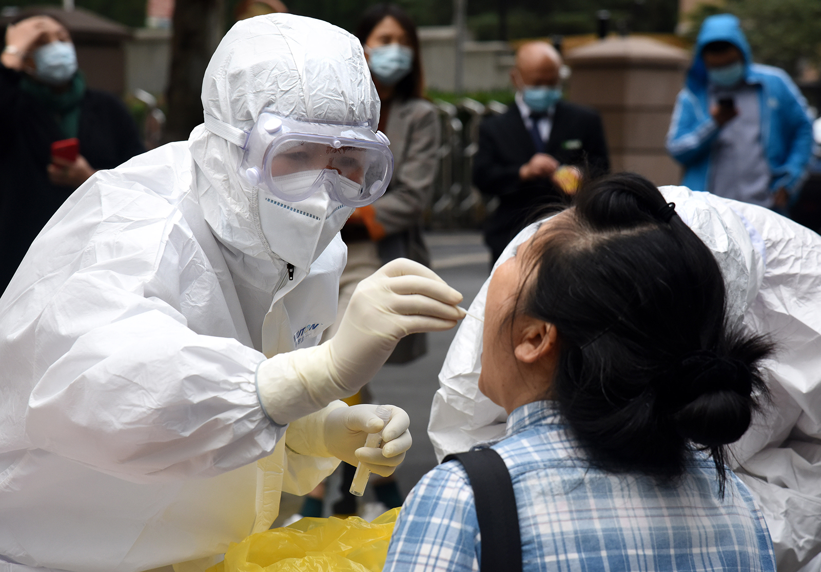 A health worker takes a swab sample from a citizen for a Covid-19 test in Qingdao, China, on October 12.