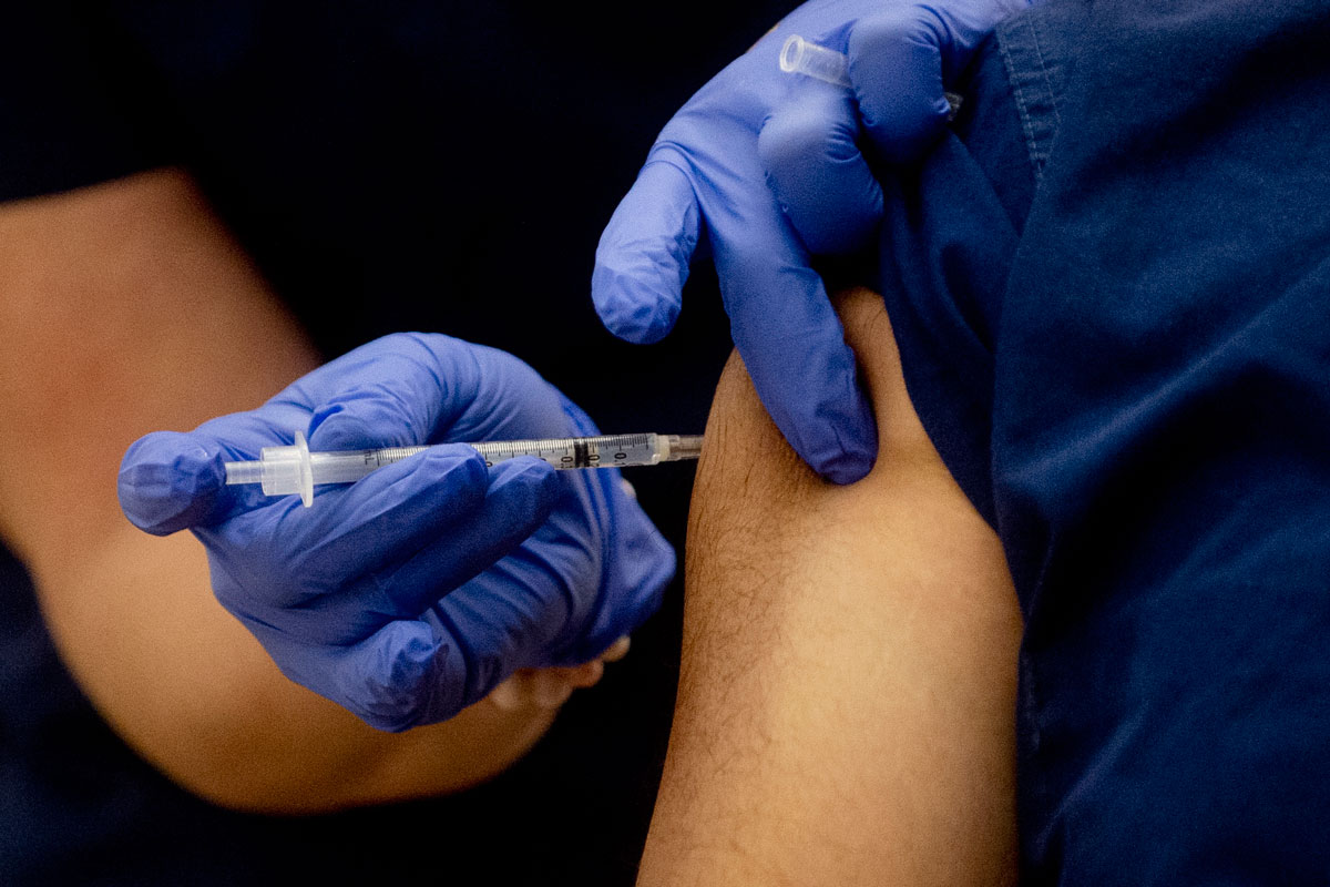 A physican receives a Pfizer Covid-19 vaccine shot at McLaren Flint Hospital on December 17 in Flint, Michigan.
