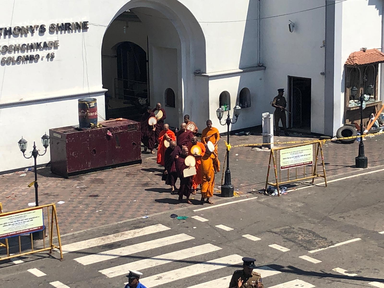 Buddhist monks arrive at St. Anthony's Shrine in Colombo, one of the sites attacked on Sunday.