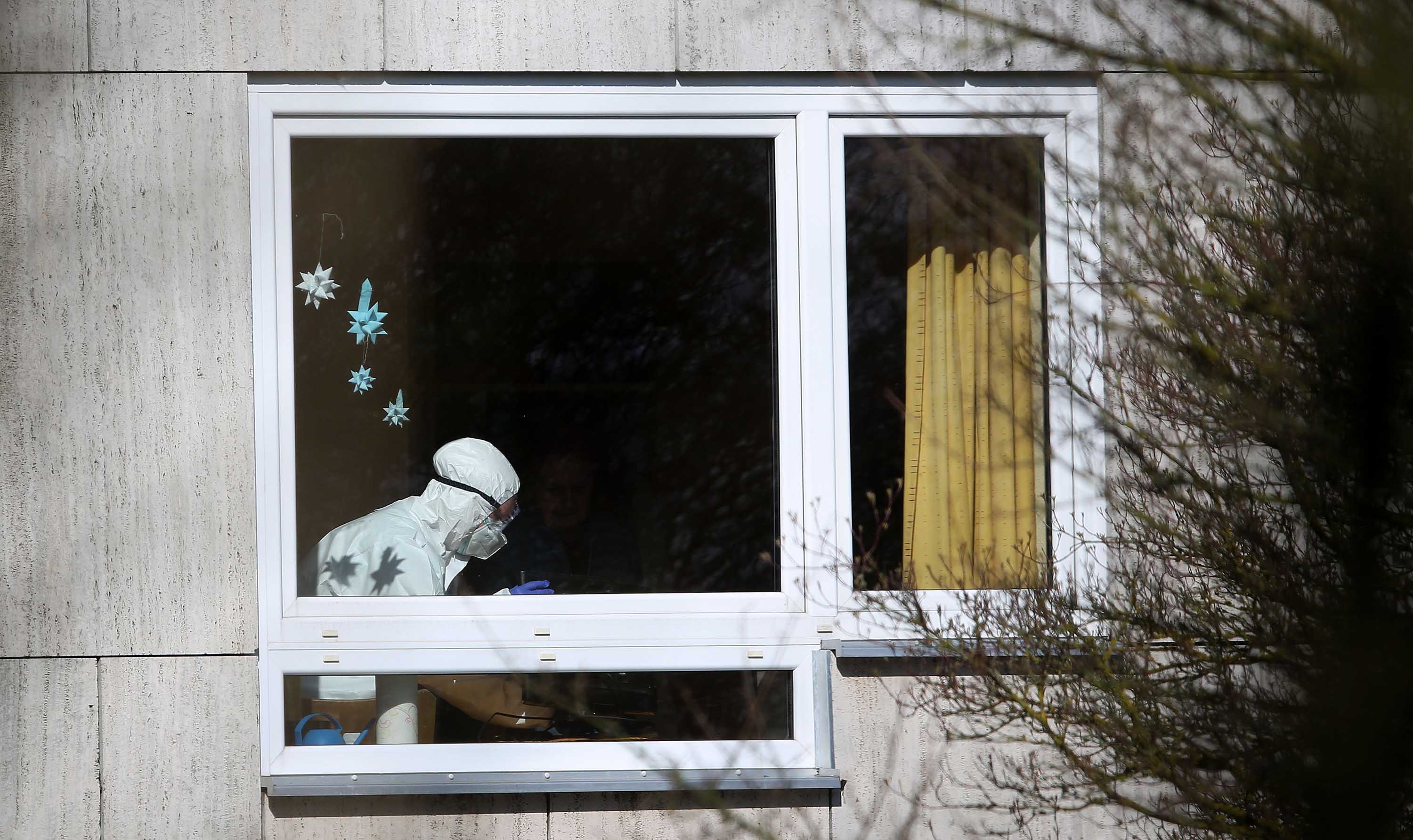 An employee works inside the Hanns-Lilje-Heim senior care home on March 31, in Wolfsburg, Germany, where coronavirus cases have been detected among residents.