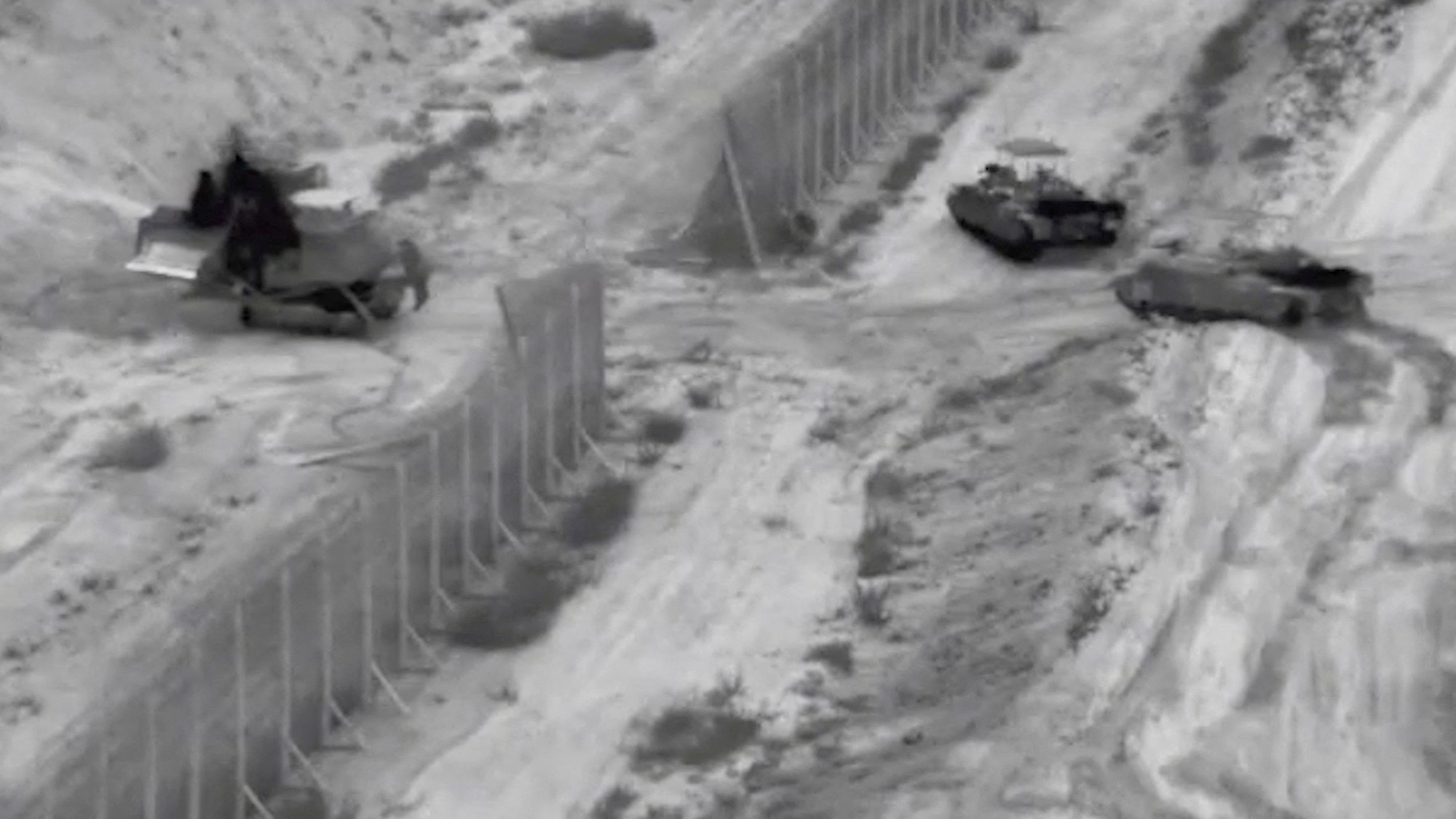 Israeli armored vehicles take part in an operation at a location given as northern Gaza in this still image taken from handout video released on October 26.